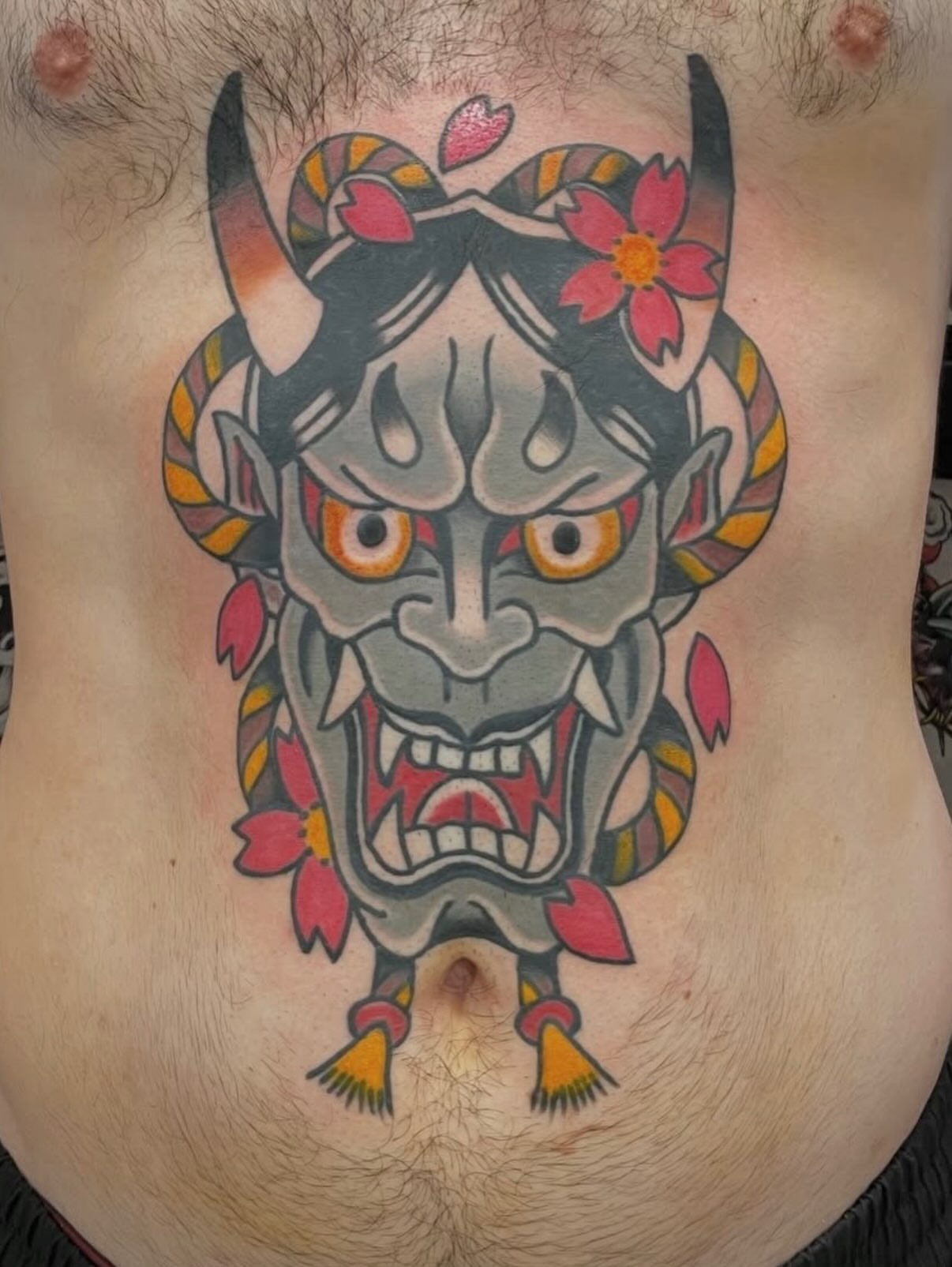 Demon mask American traditional tattoo on the chest by Greg De Hoot, Youngsville, North Carolina