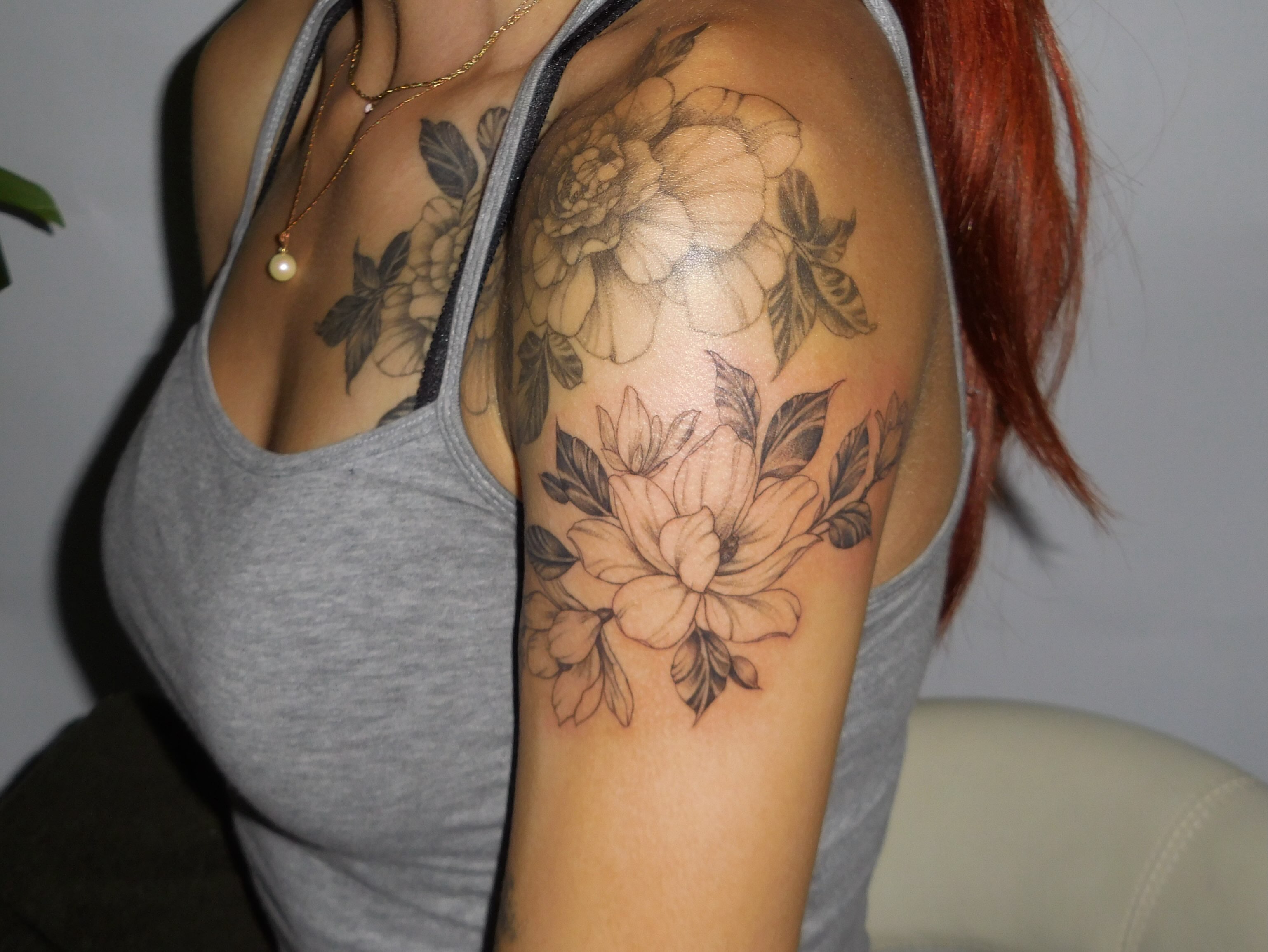 Floral bouquet black and grey tattoo on the shoulder by Nevaeh tattoo artist