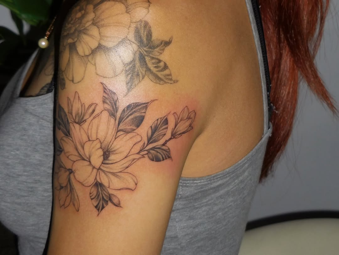 Flower bouquet black and grey tattoo on the shoulder by Nevaeh tattoo artist
