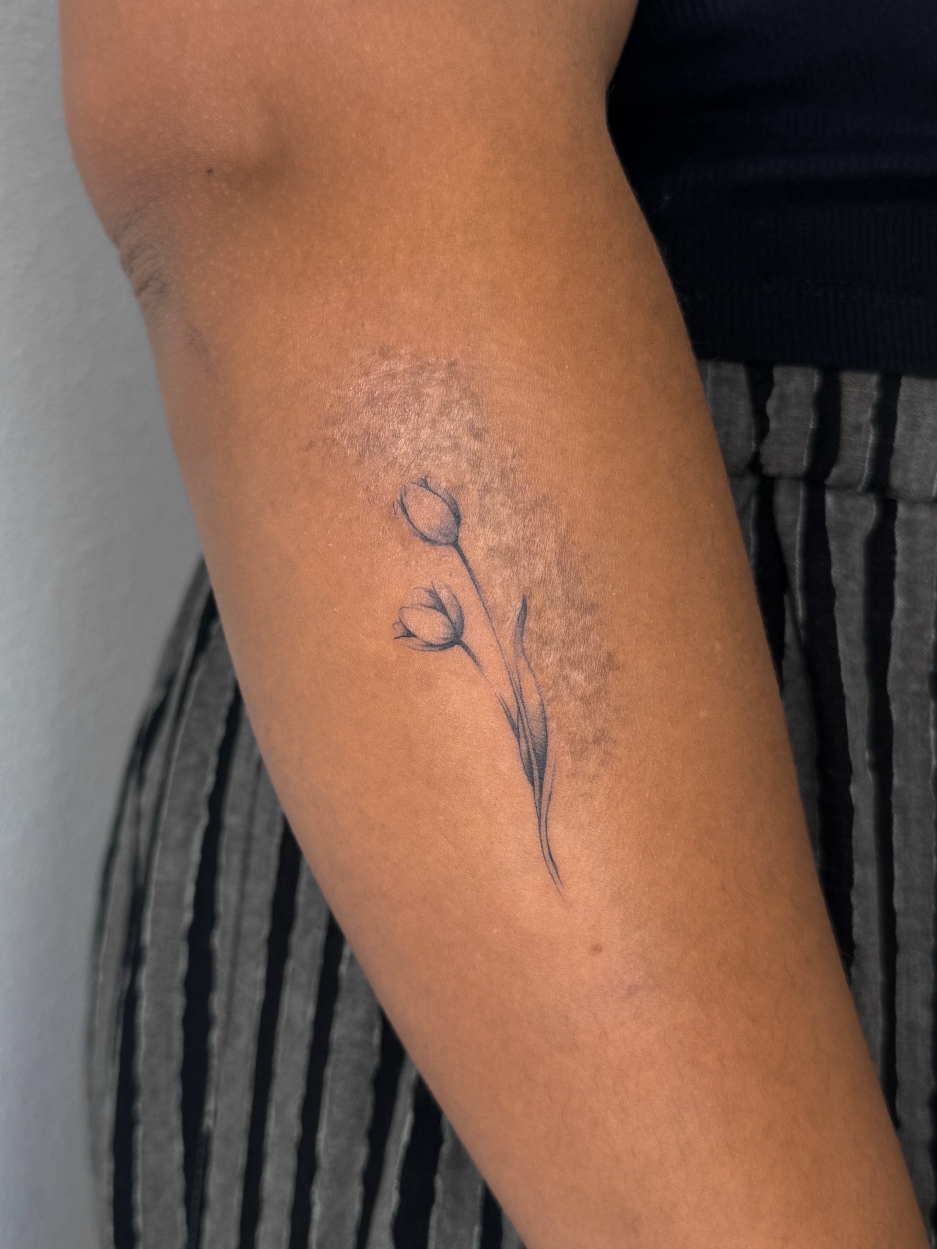 Flower black and grey tattoo on the forearm by Rylee