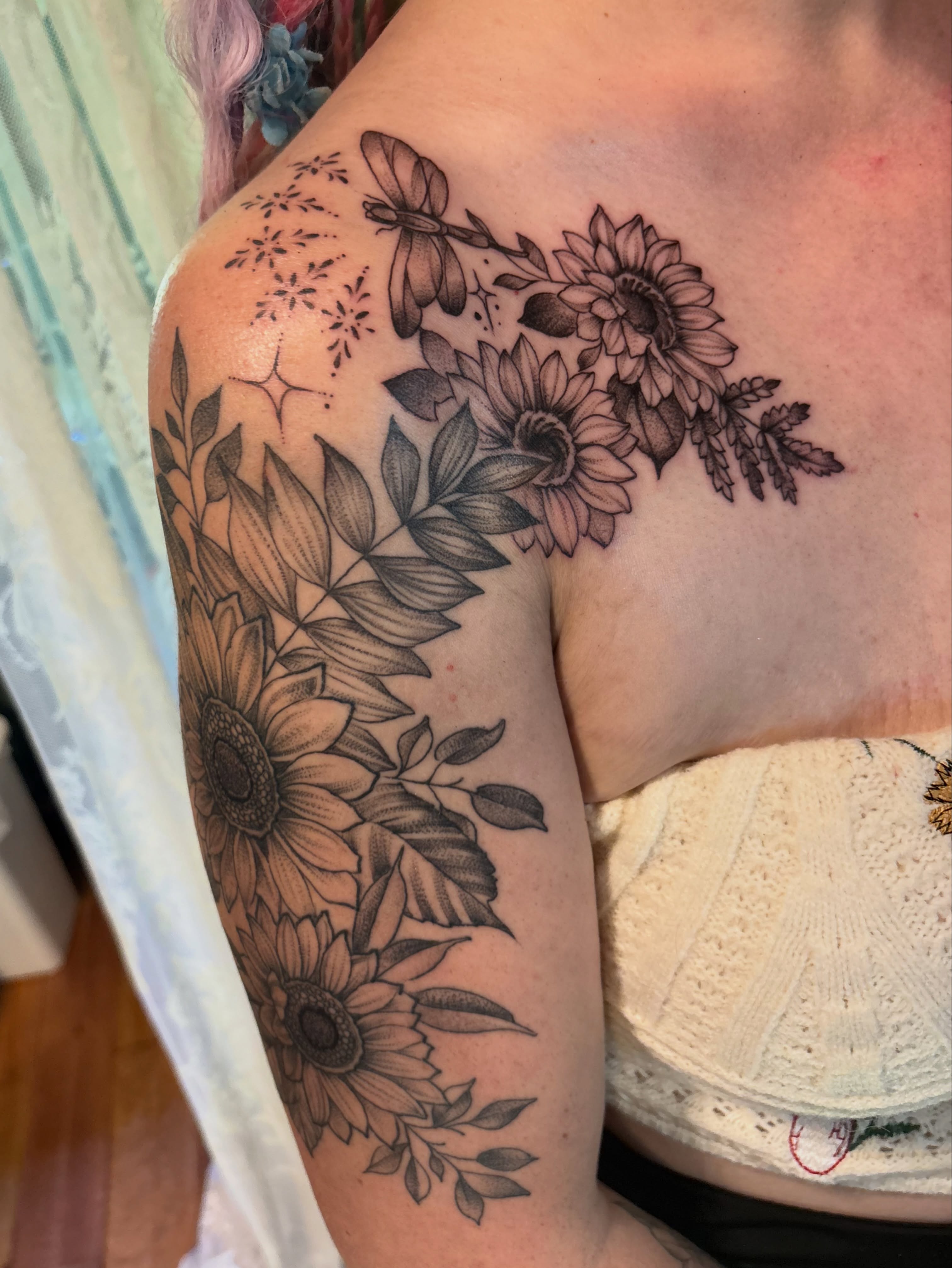 Sunflowers and leaves black and grey tattoo on the shoulder by Komfort Kristy