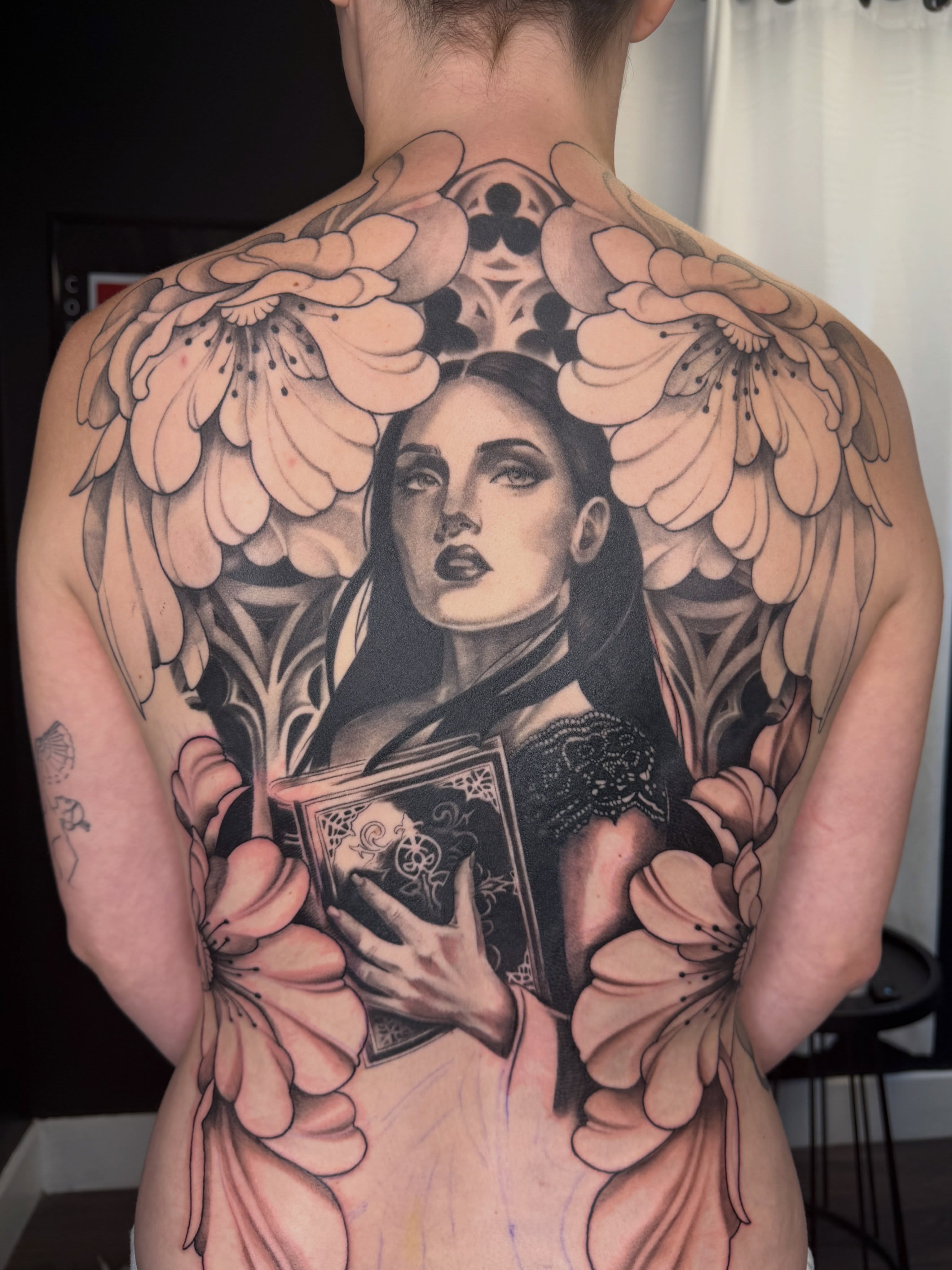 Angelic woman reading realism tattoo on the back by Red