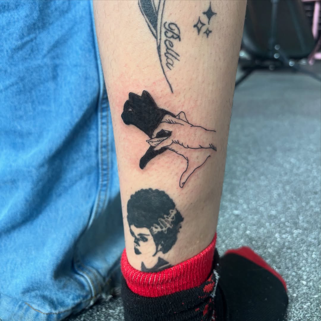 Cat silhouette black and grey tattoo on the forearm by Hiro Robinson