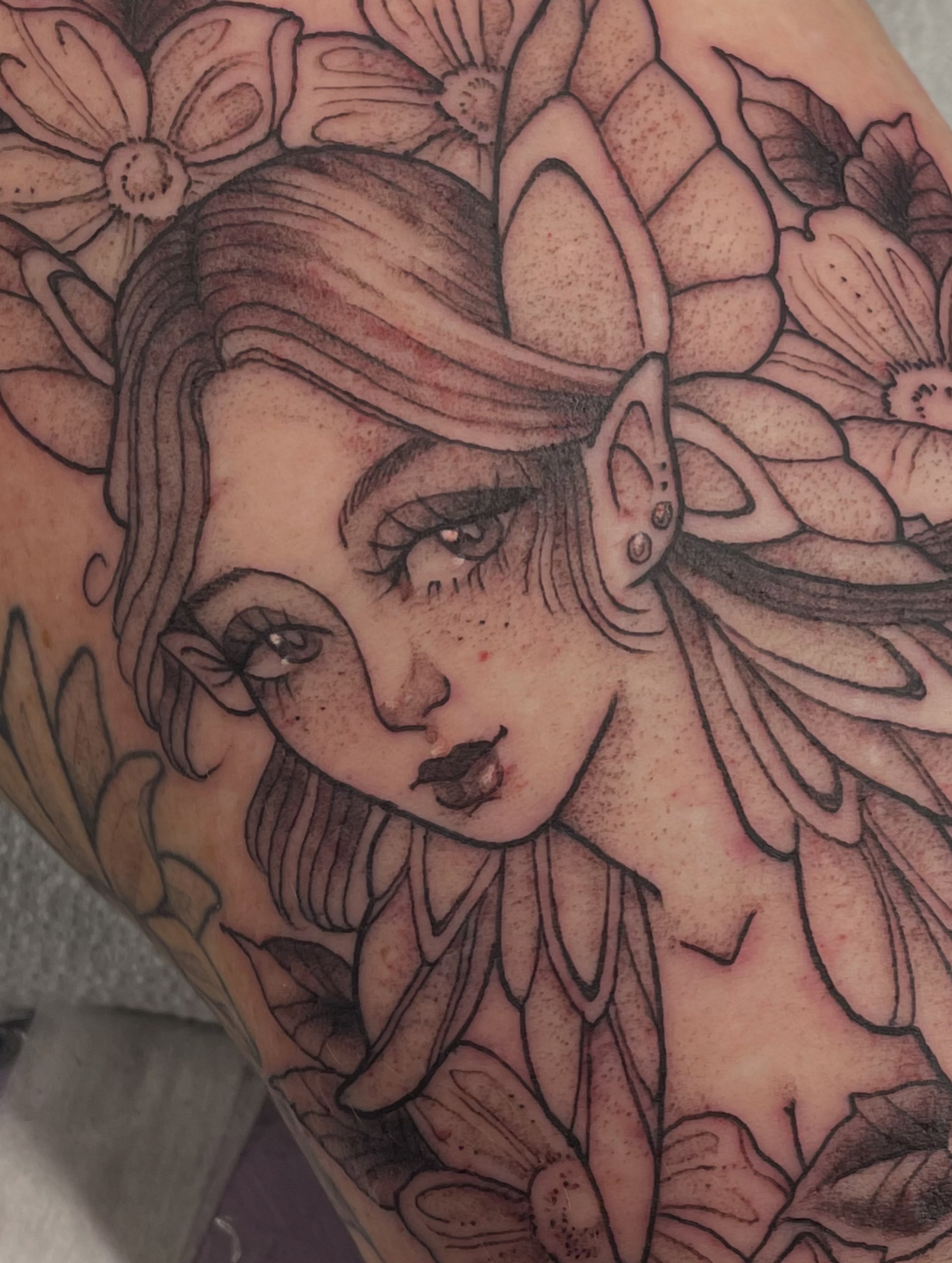 Elf-like woman realism tattoo on the forearm by Fionna Fanning