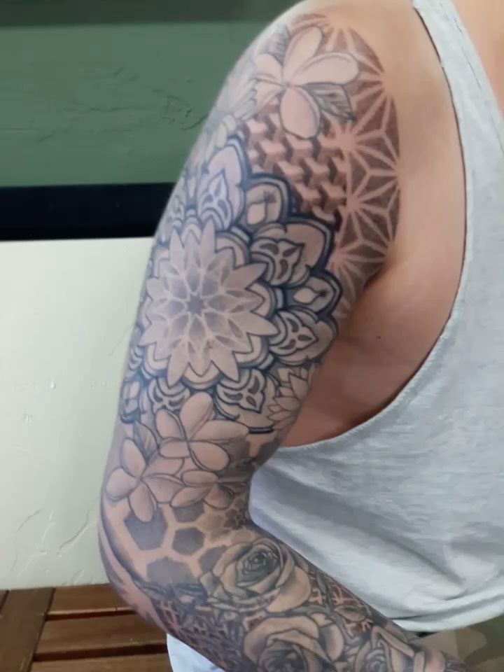 Floral bouquet geometric tattoo on the upper arm by San Diego Tattoo Artist