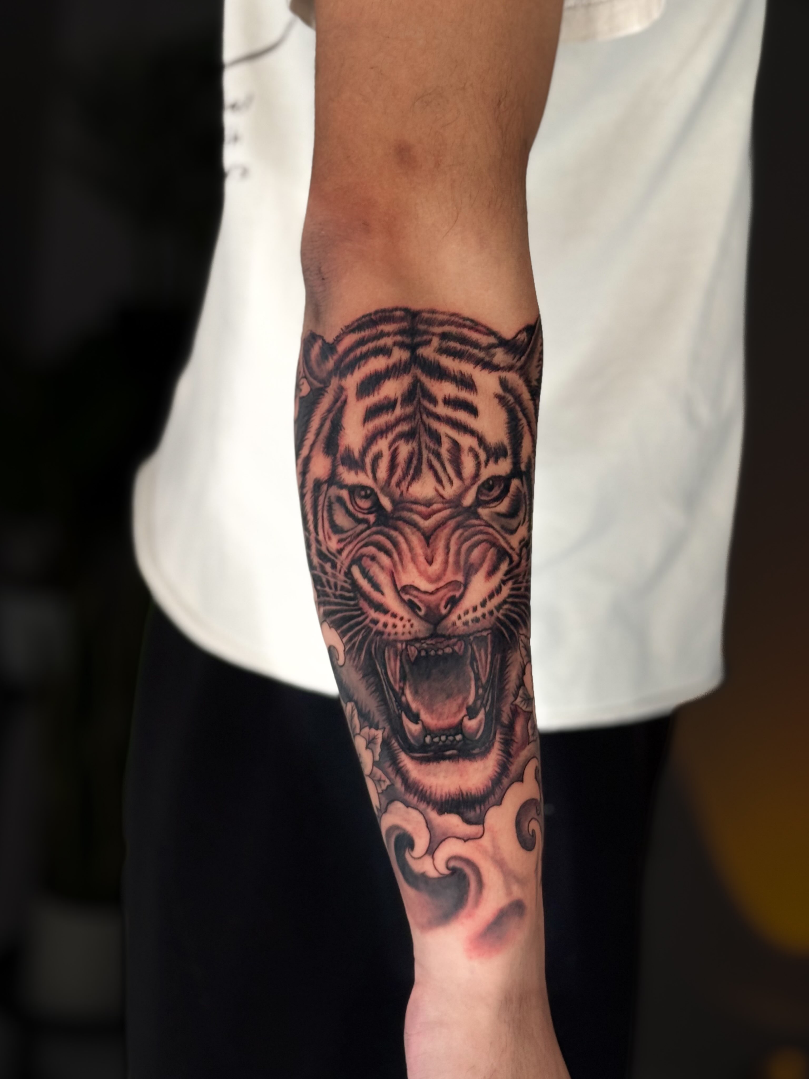 Roaring tiger realism tattoo on the forearm by Kai, Charlotte, North Carolina