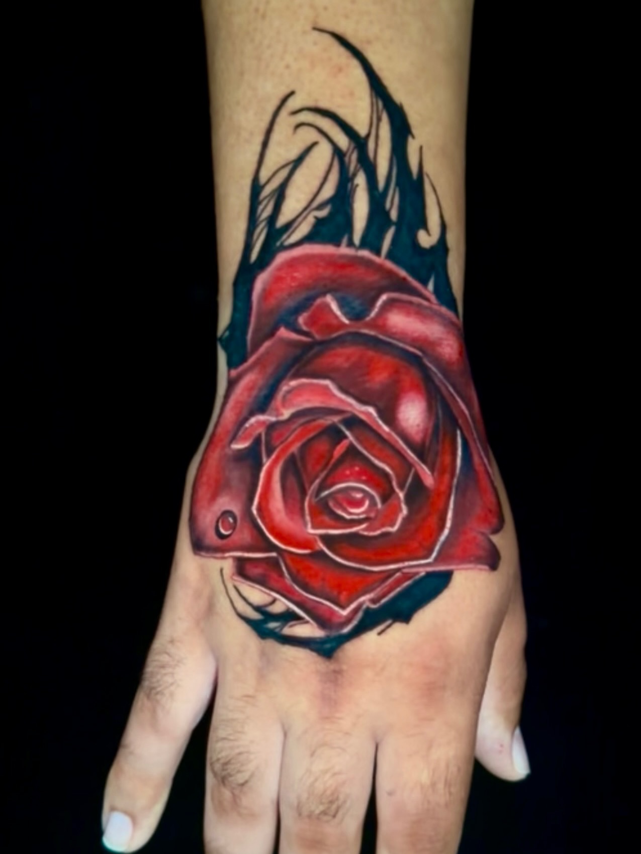 Red rose realism tattoo on the hand by Goga