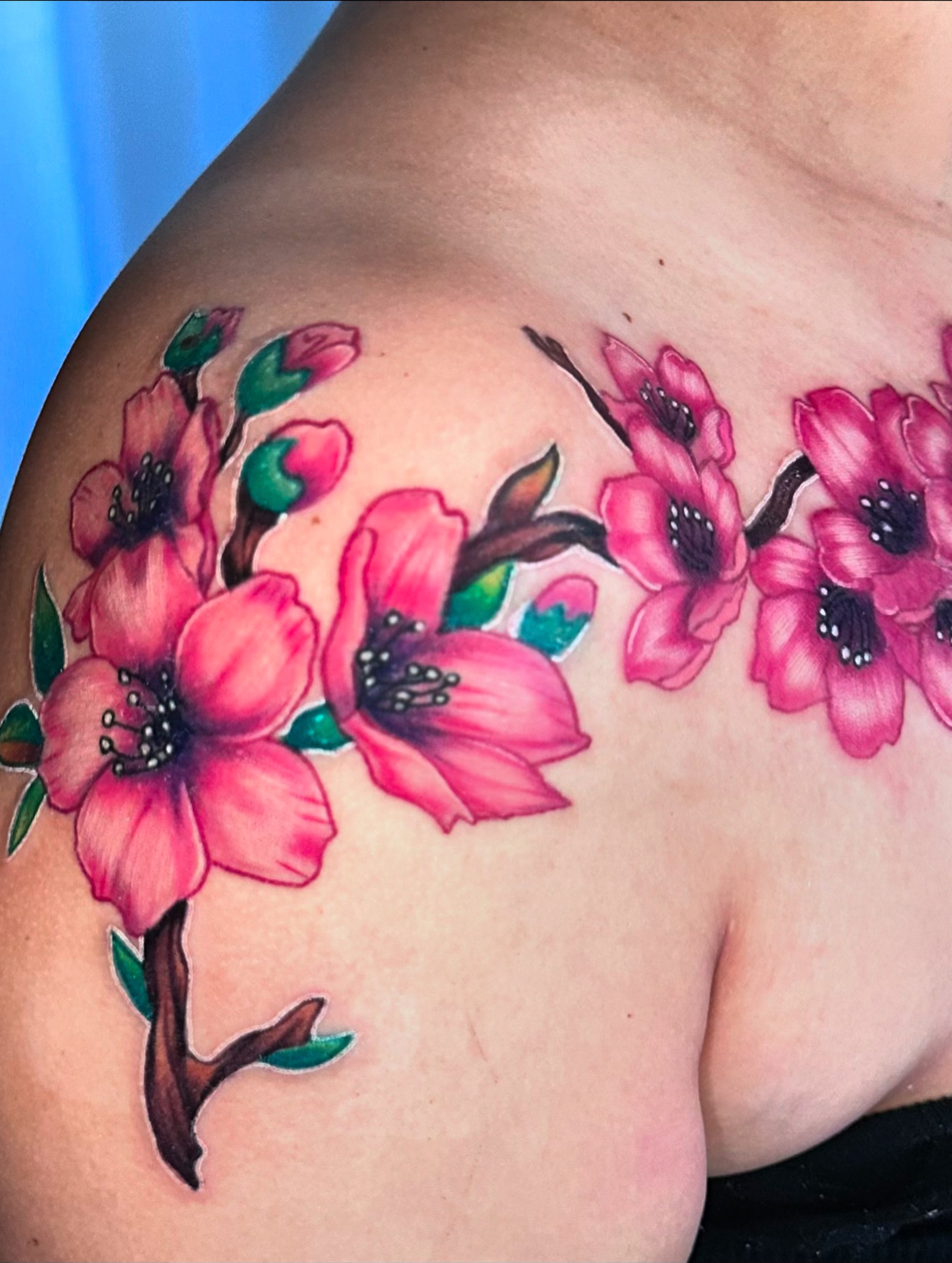 Cherry blossoms realism tattoo on the shoulder by Goga
