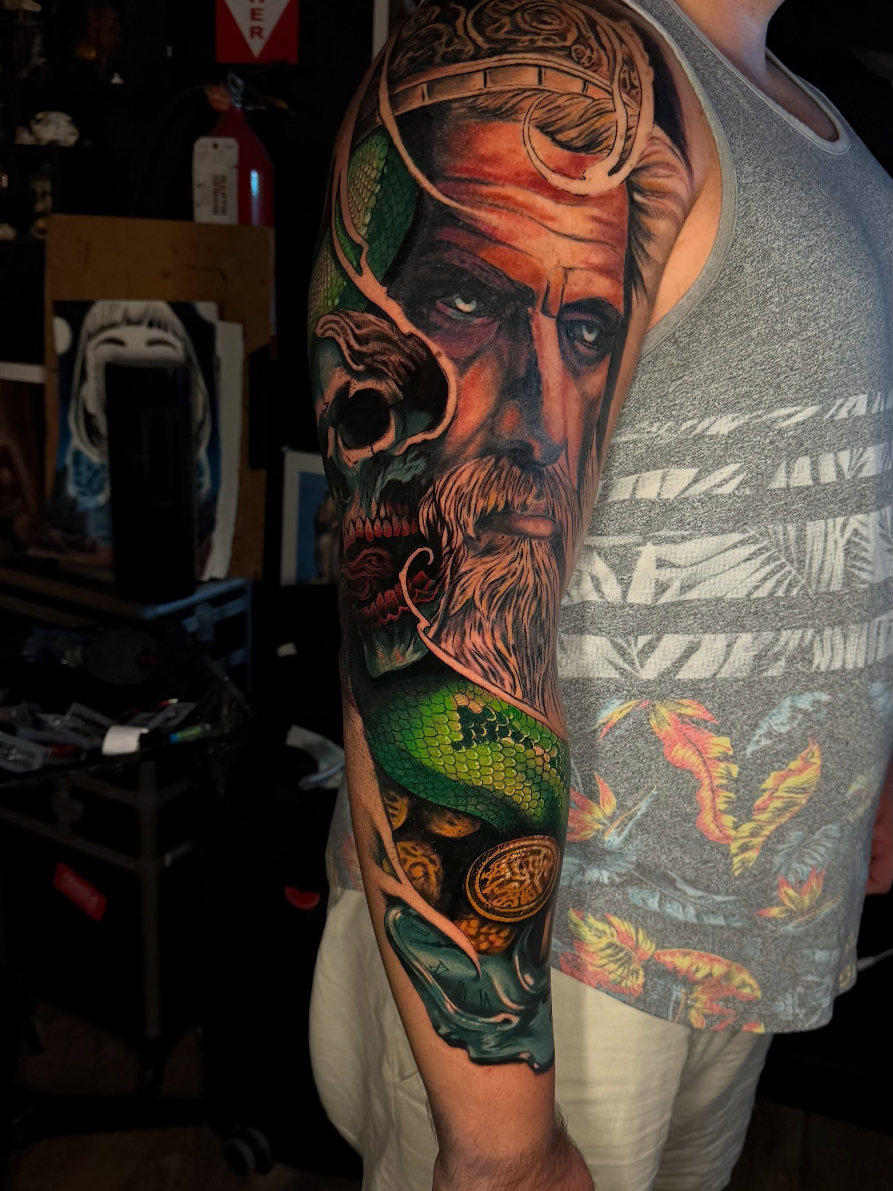 Bearded man with snake realism tattoo on the forearm by Dean Rogers