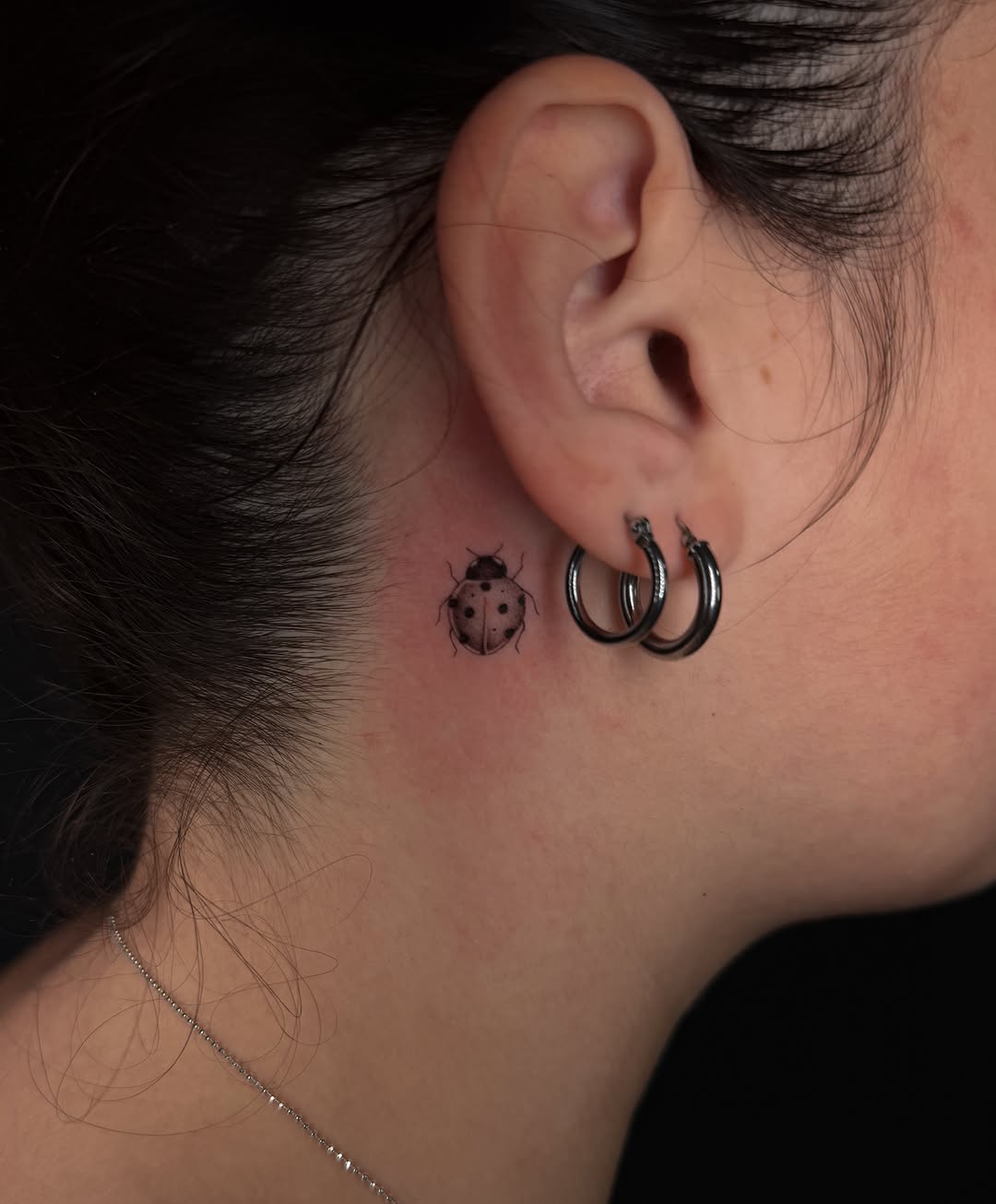 Ladybug realism tattoo on the neck by Marianne
