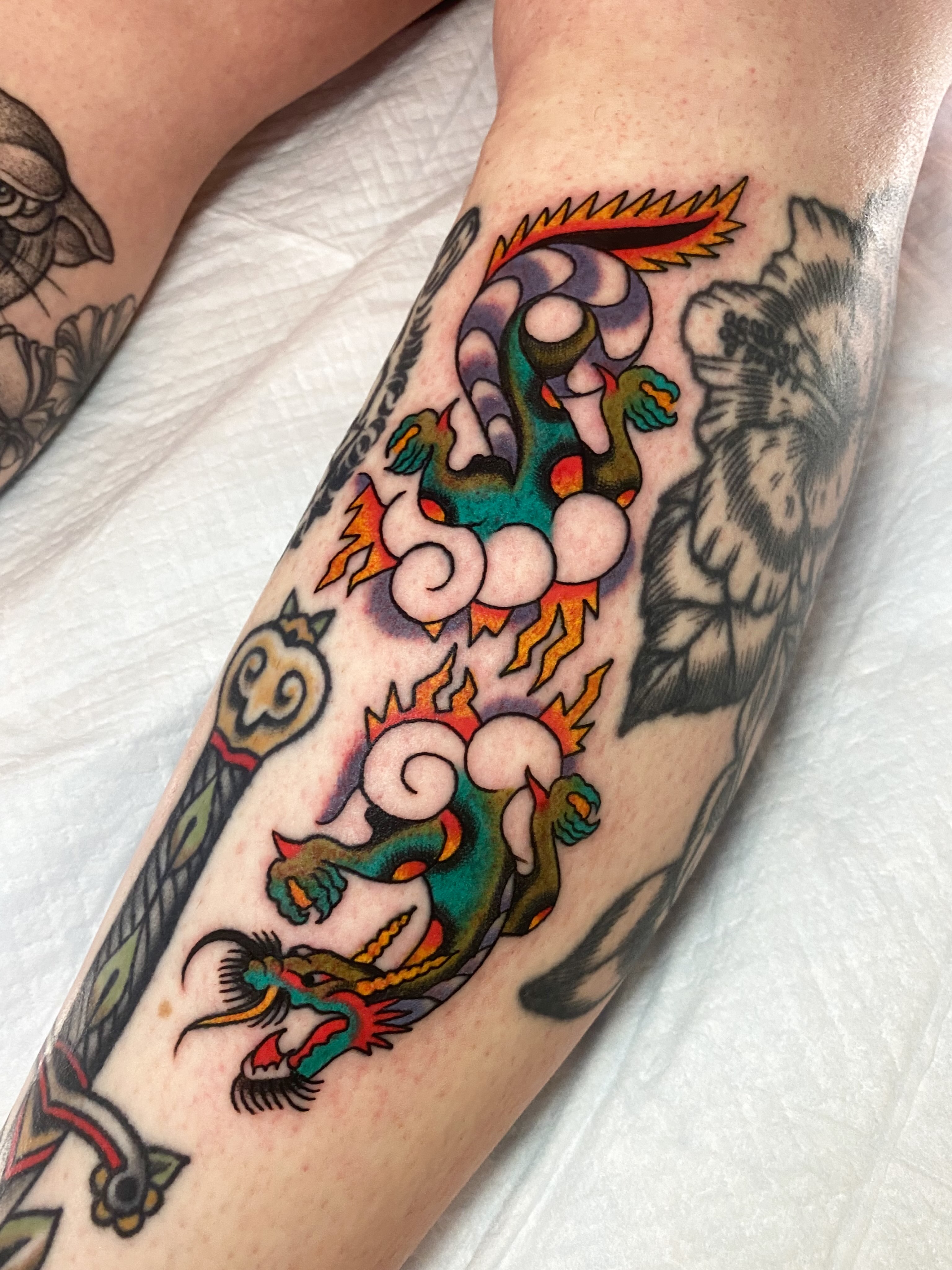Dragon and flames American traditional tattoo on the forearm by Jaclin Grace Hastings