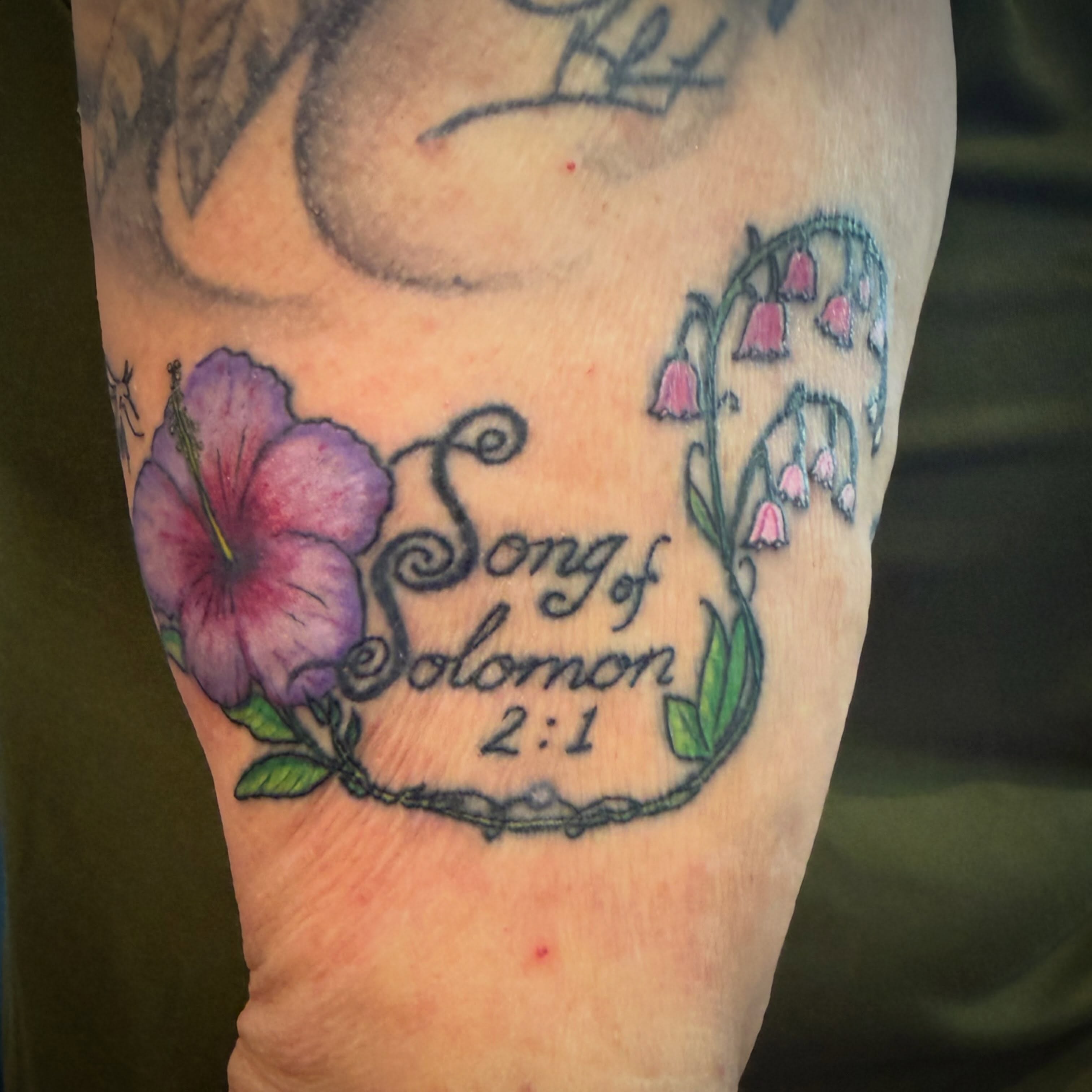 Song of Solomon 2:1 lettering script tattoo on the forearm by Darby Antonucci