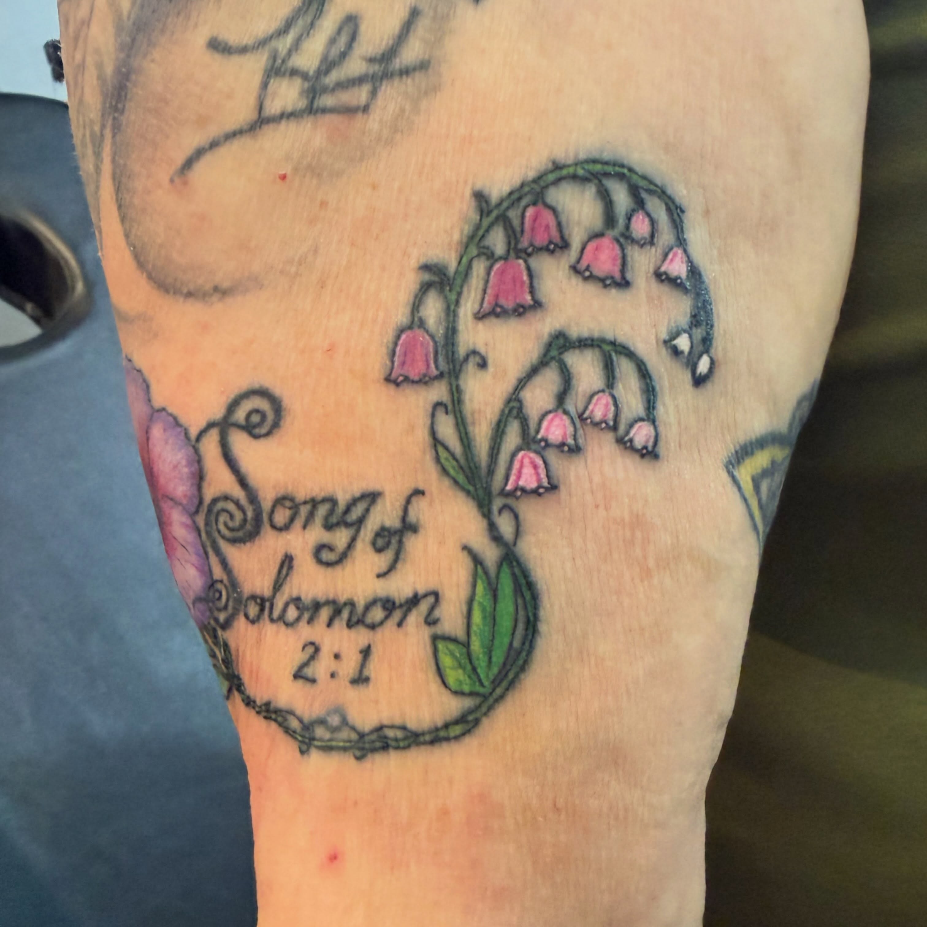 Lily of the valley fine line tattoo on the forearm by Darby Antonucci