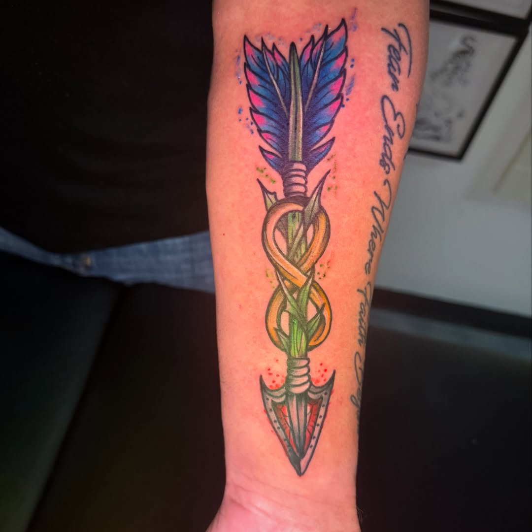 Arrow with infinity symbol new school tattoo on the forearm by Arron Albaugh