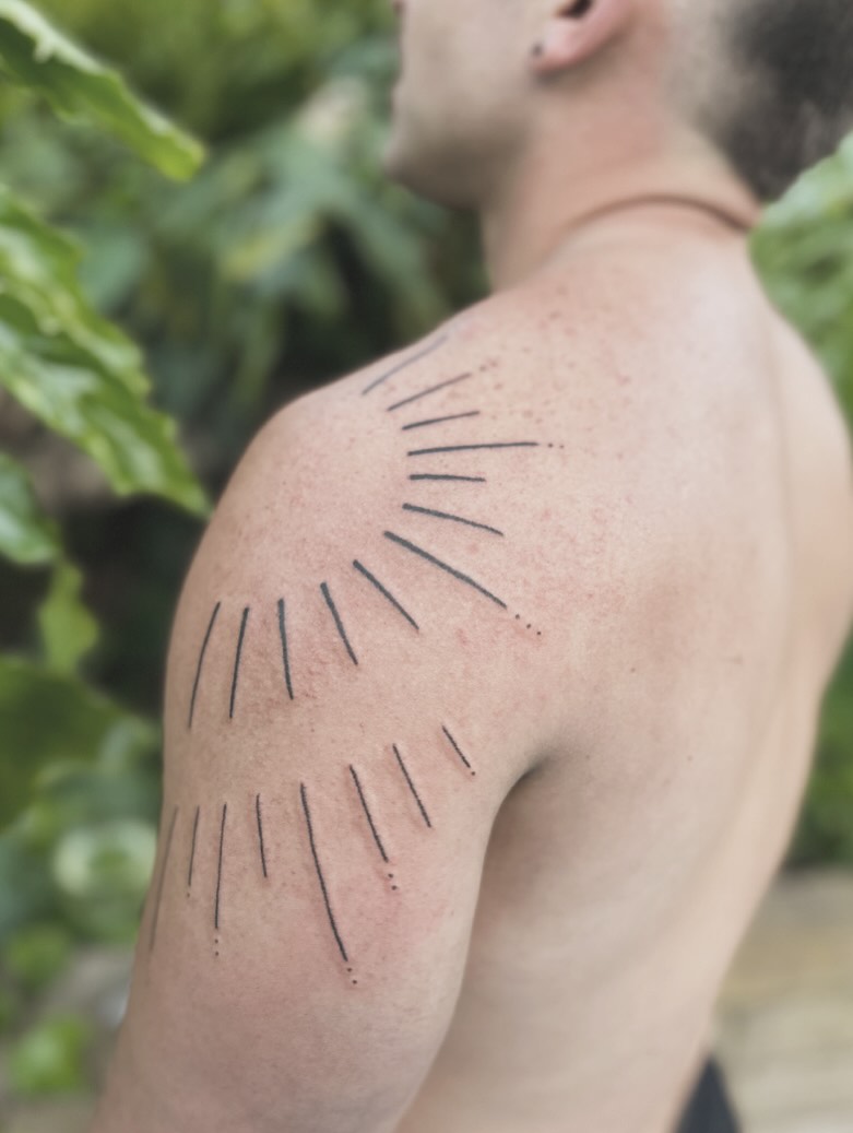 Sunburst dotwork tattoo on the shoulder by Gaya