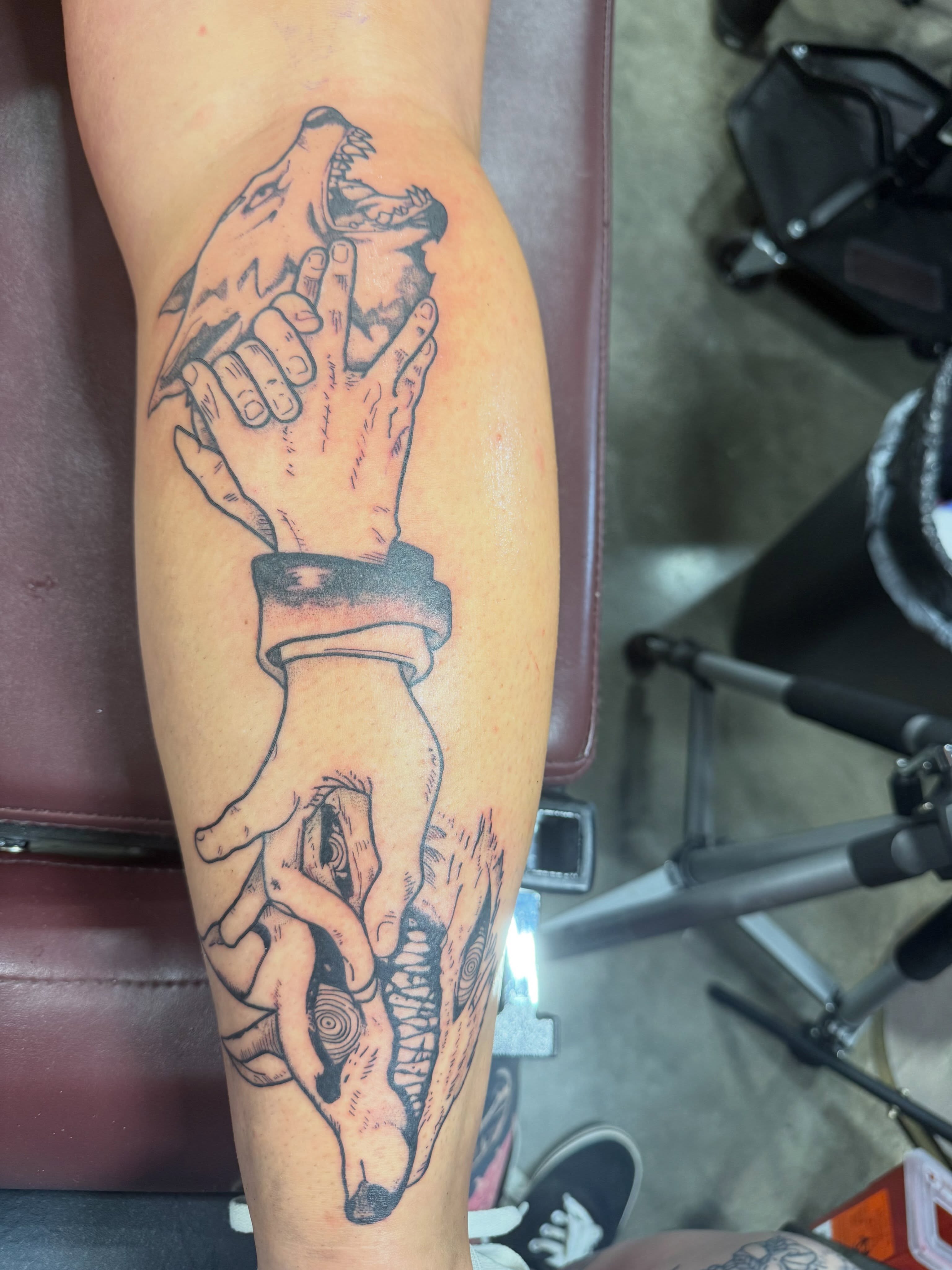 Wolf and hands black and grey tattoo on the forearm by Brandie Caroline, Somers Point, New Jersey