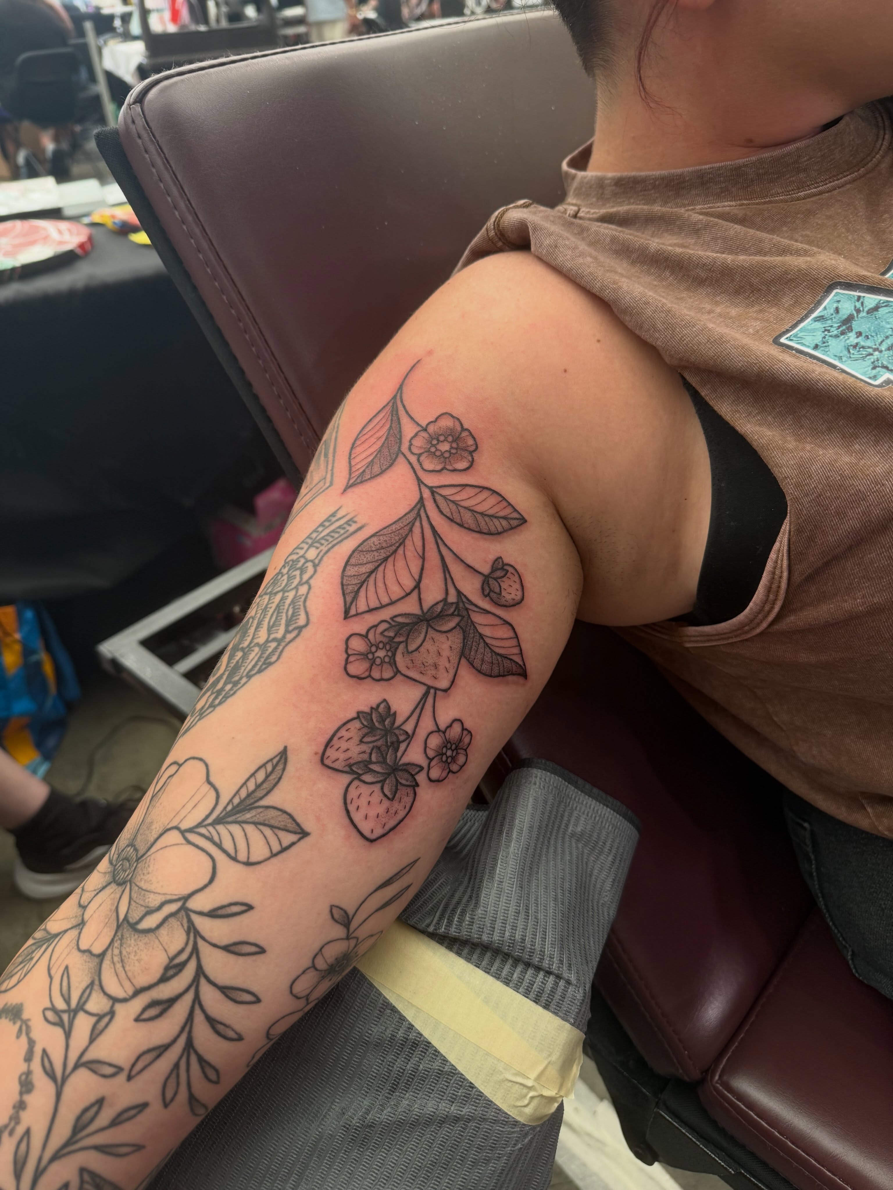 Strawberries and flowers black and grey tattoo on the forearm by Brandie Caroline, Somers Point, New Jersey