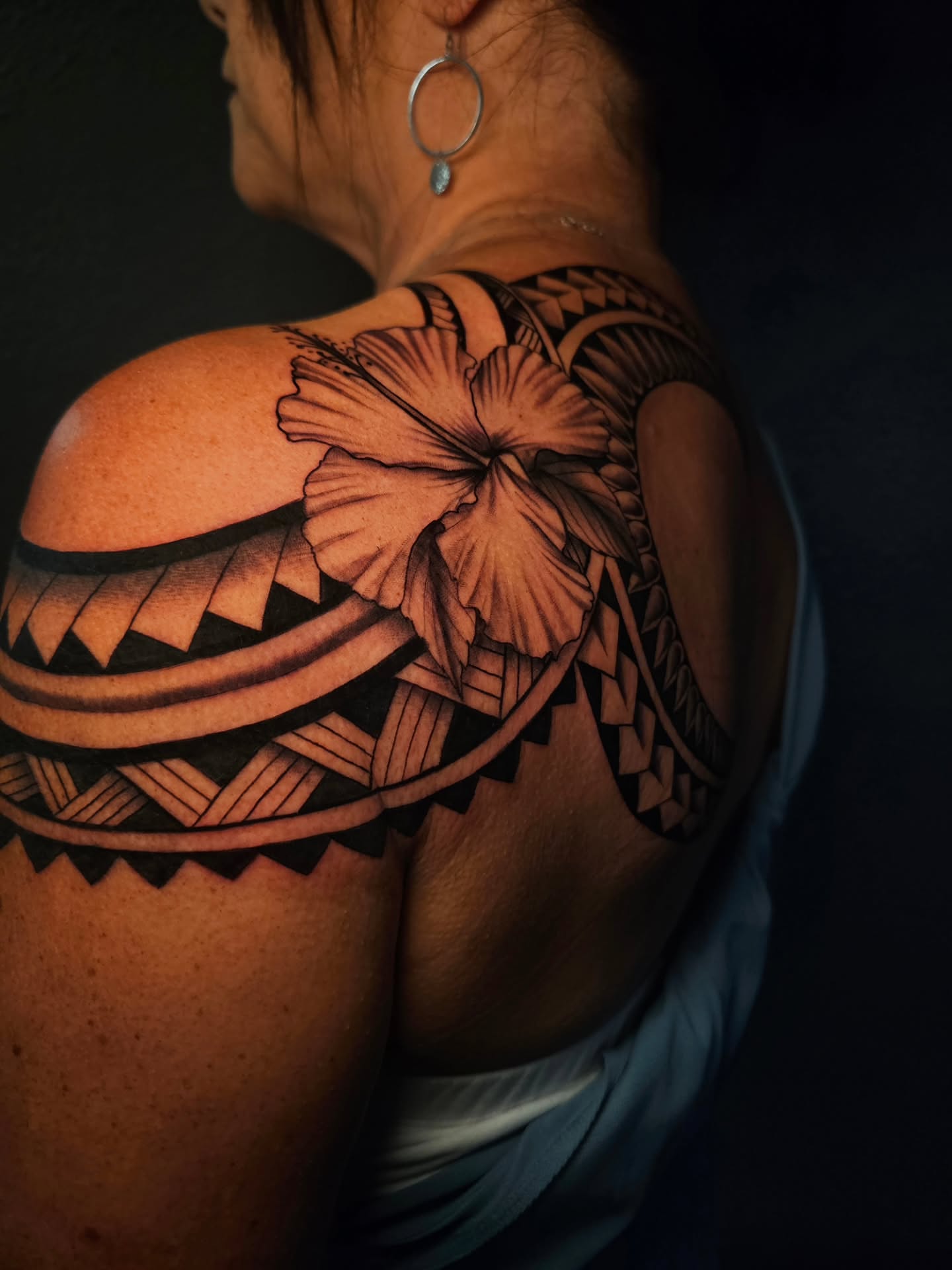 Hawaiian flower tribal tattoo on the shoulder by Adriannah Esparza