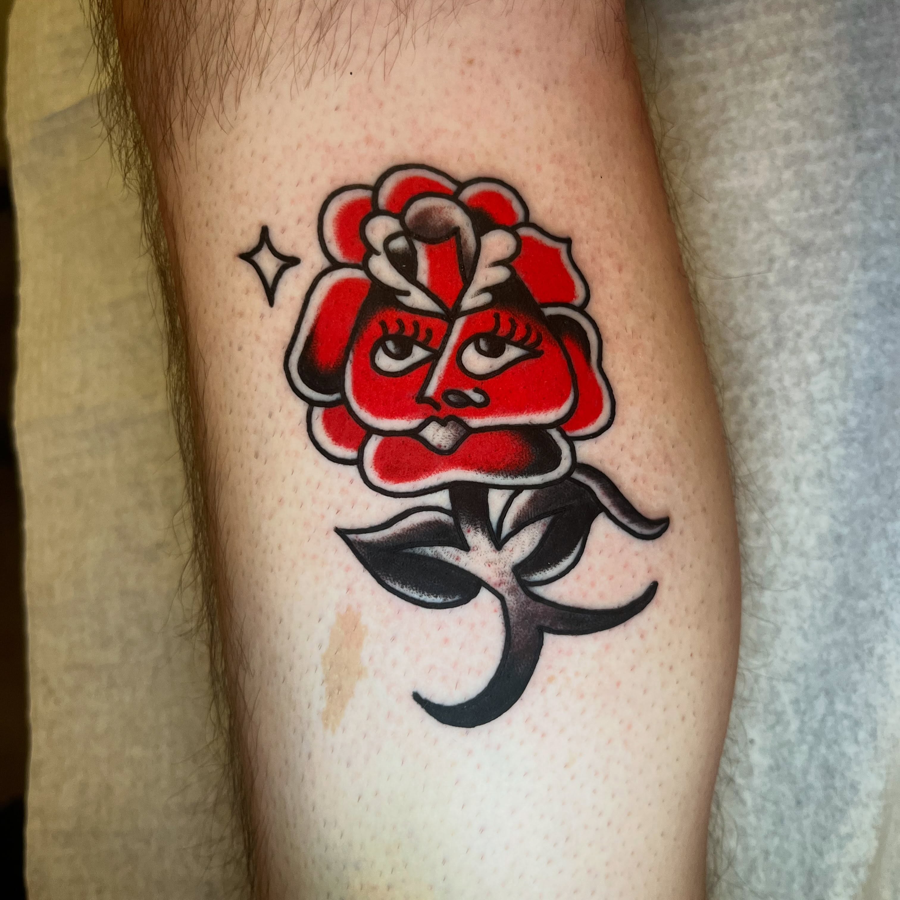 Rose with face American traditional tattoo on the forearm by Rizzo