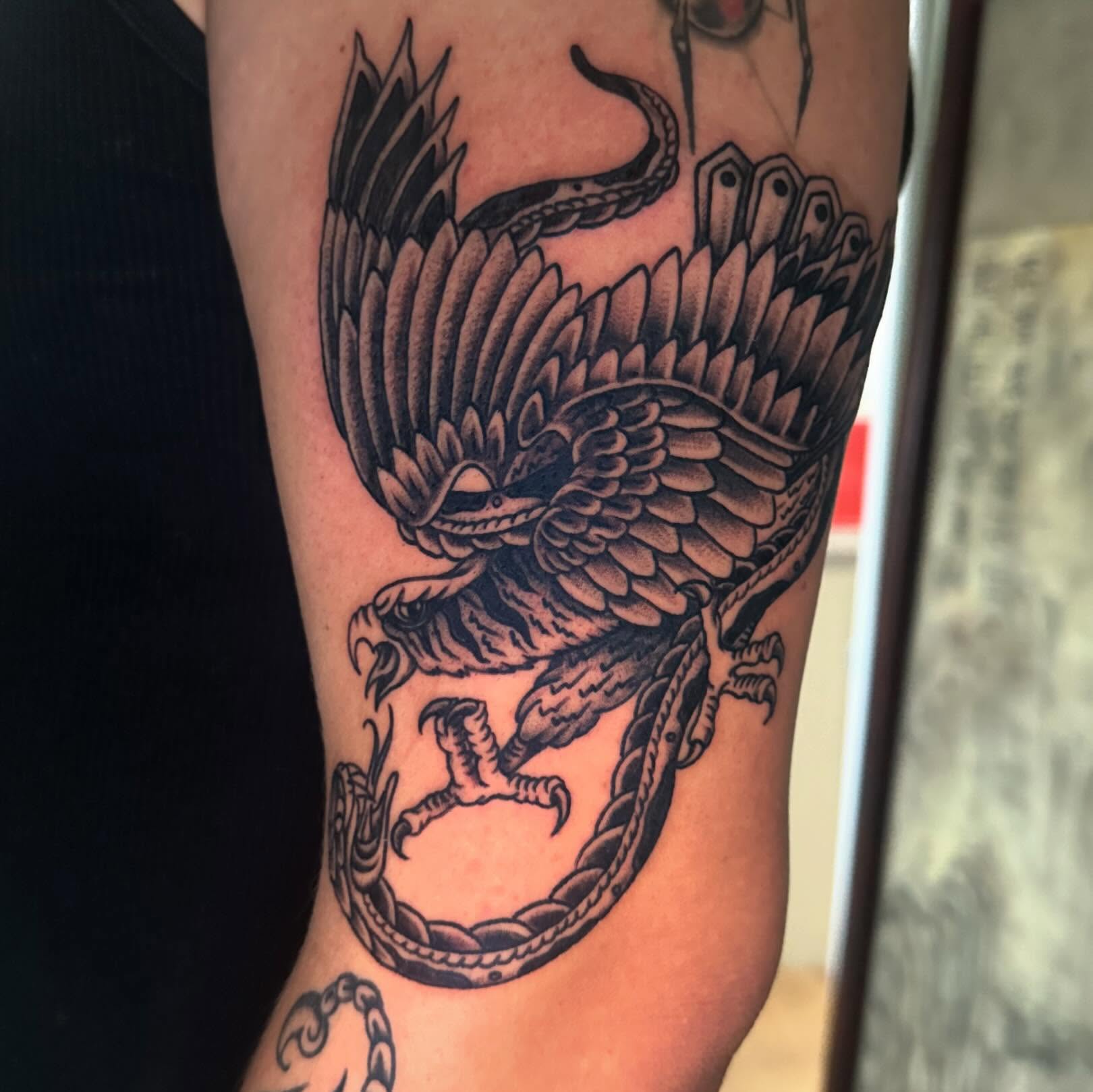 Eagle and snake black and grey tattoo on the forearm by Kaylee Woods