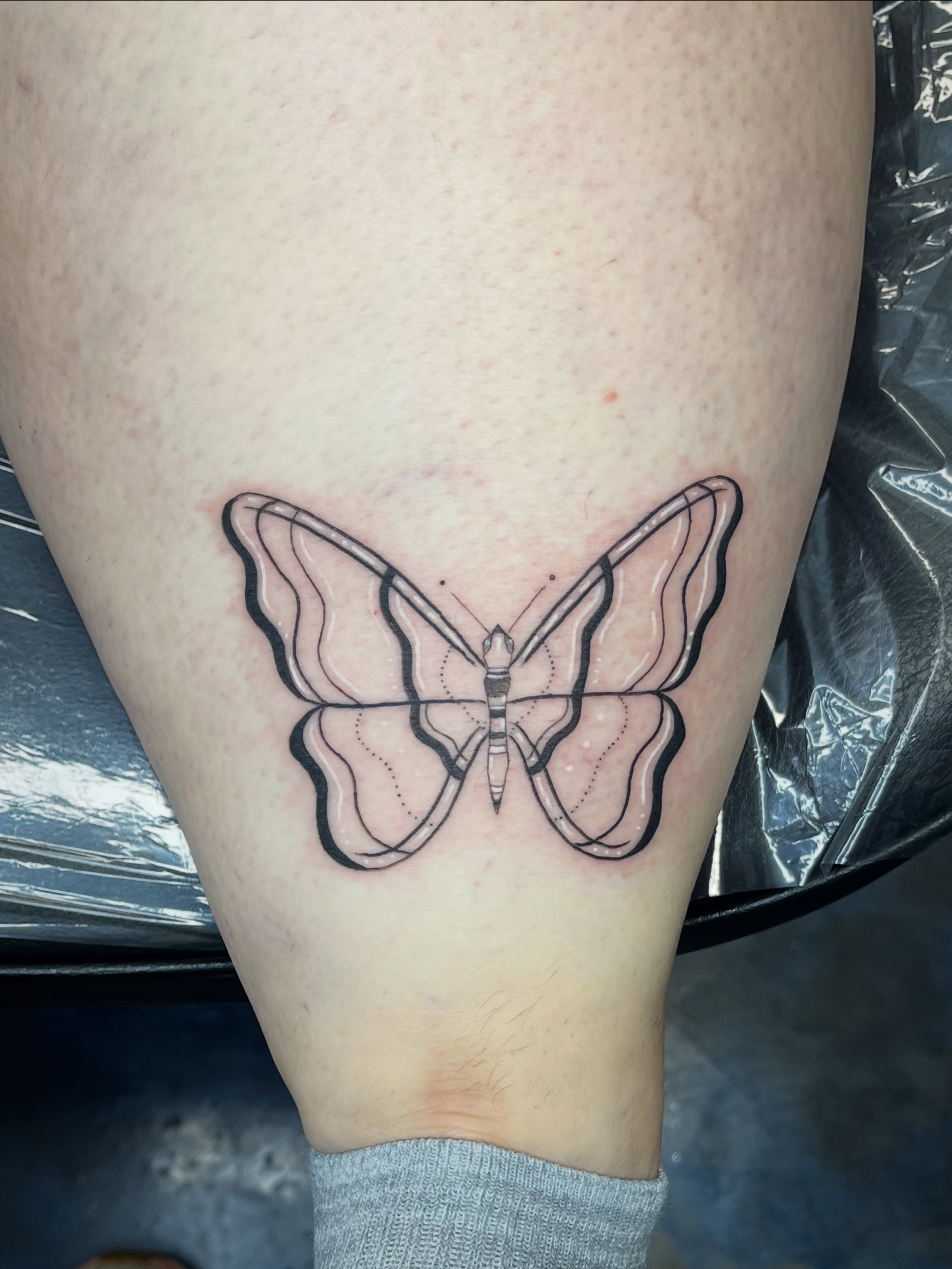 Butterfly geometric tattoo on the thigh by Sid