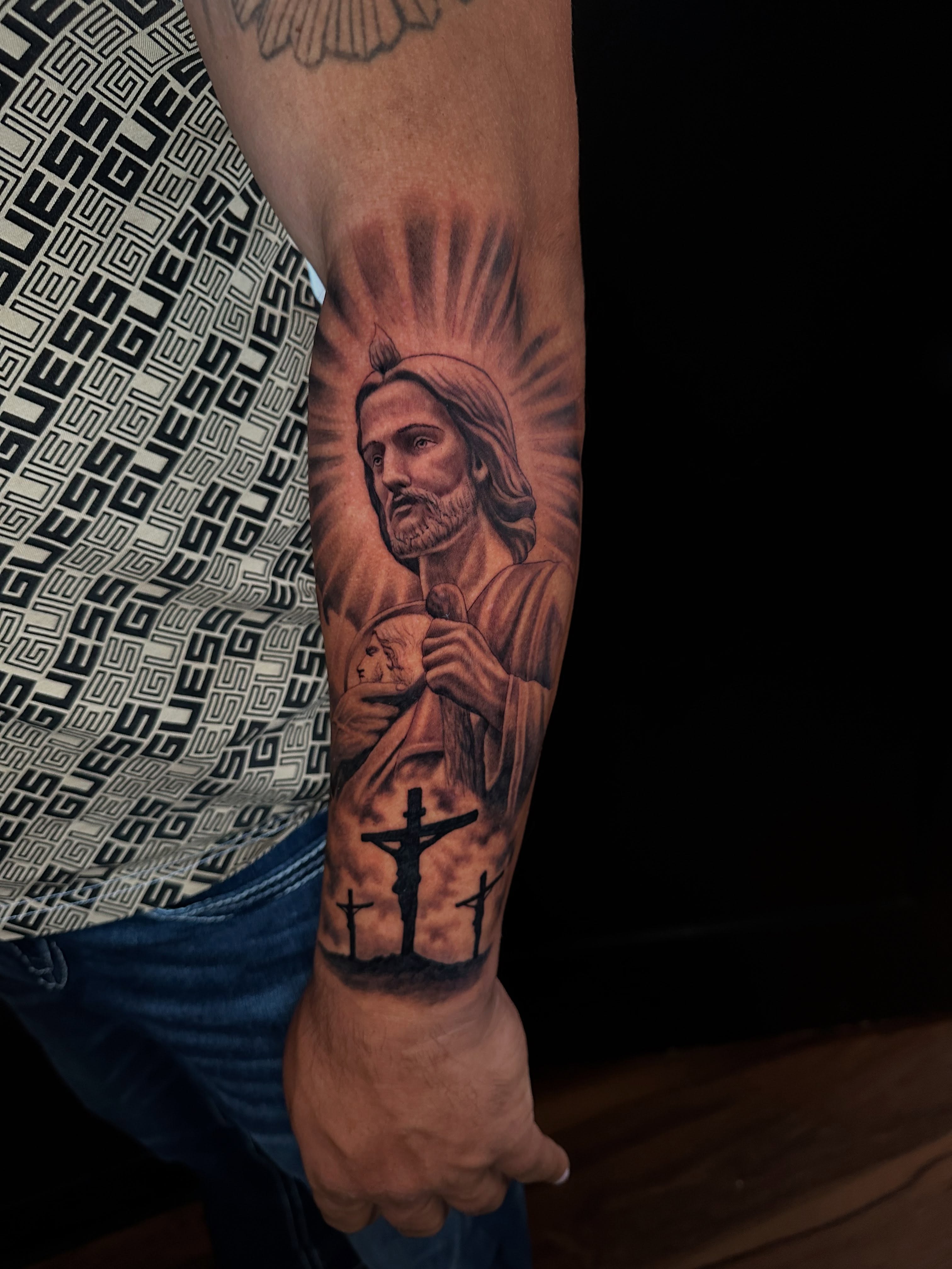 Religious figure black and grey tattoo on the forearm by Mario Flores Tattoo