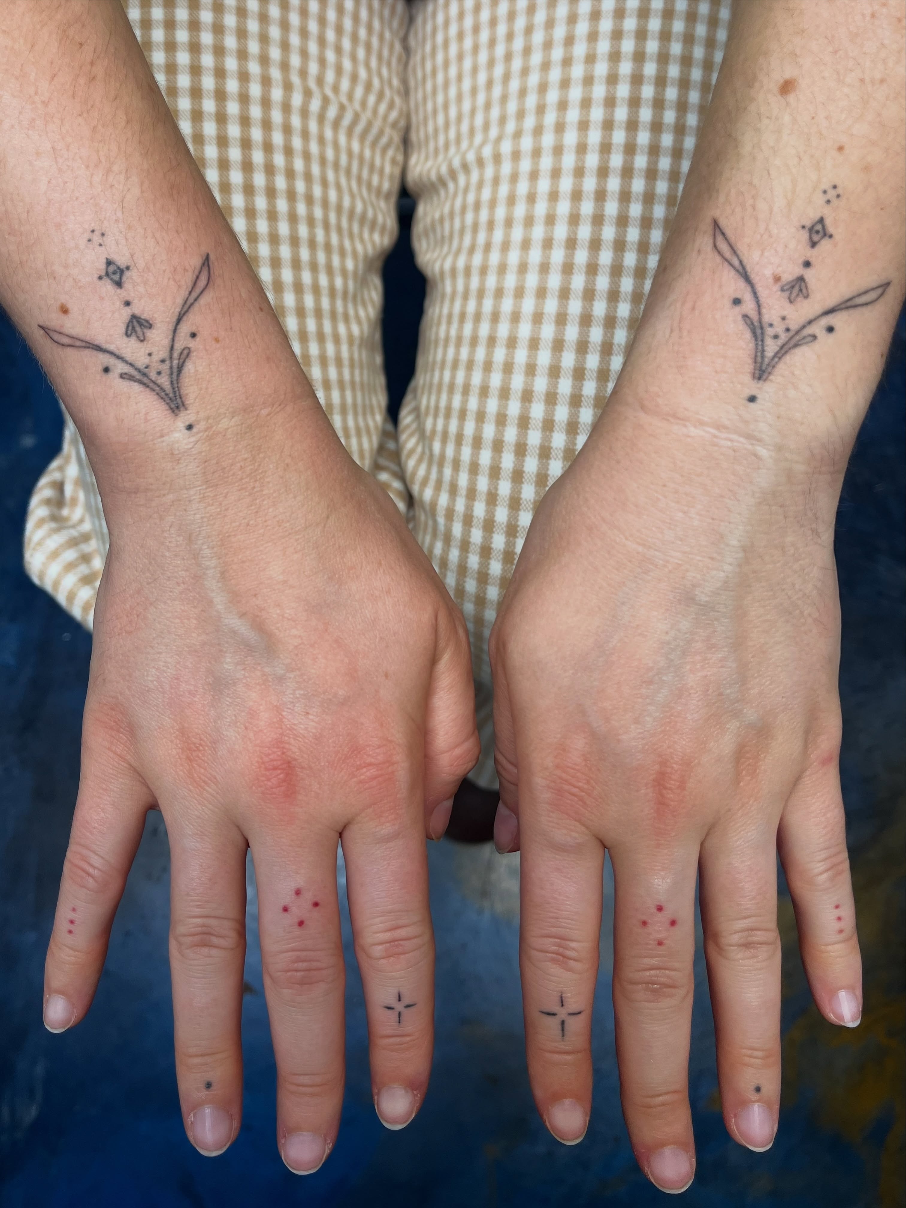 Floral design fine line tattoo on the hand by Sid