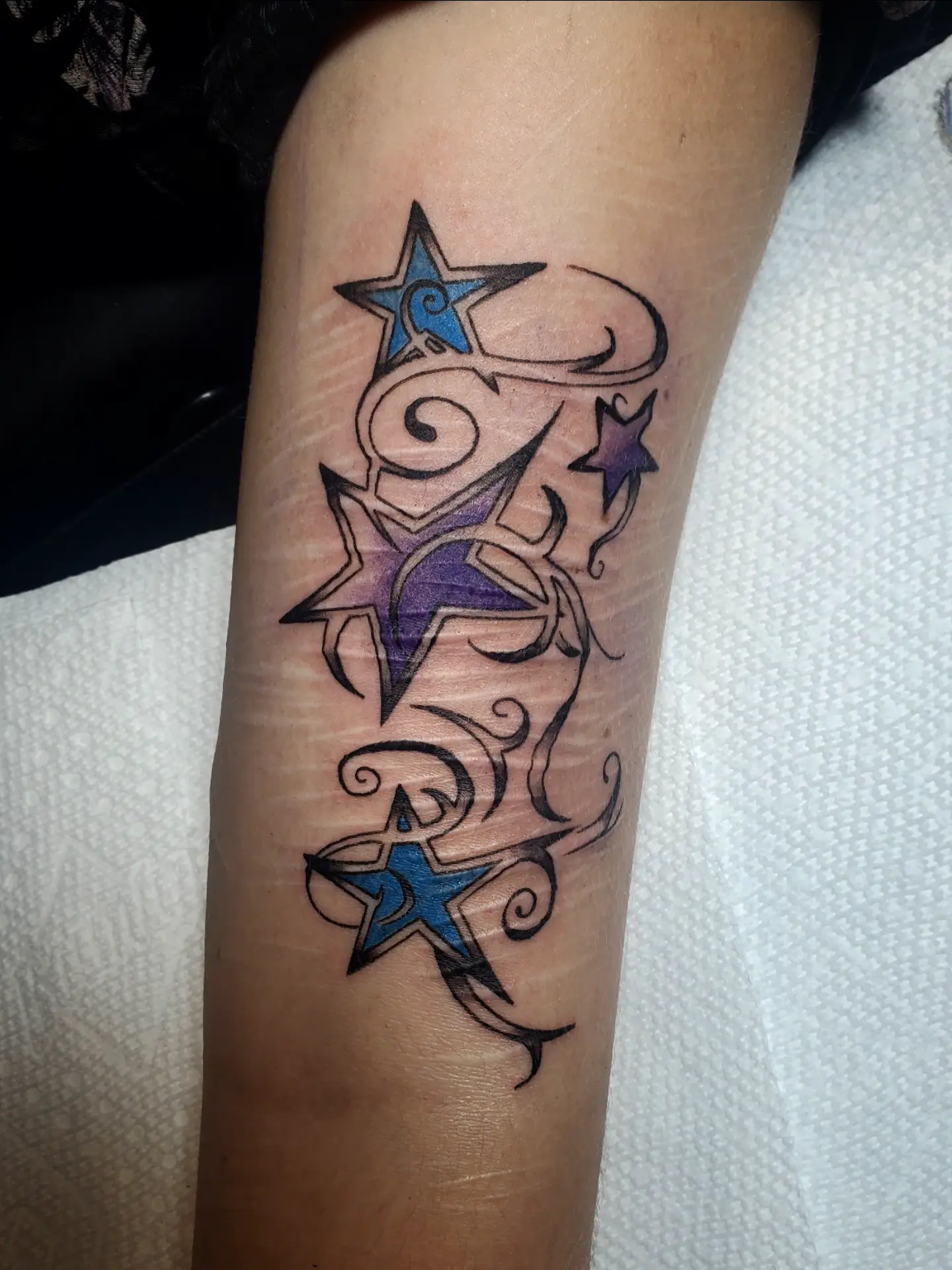 Stars and swirls tribal tattoo on the forearm by Shailey Pasquale