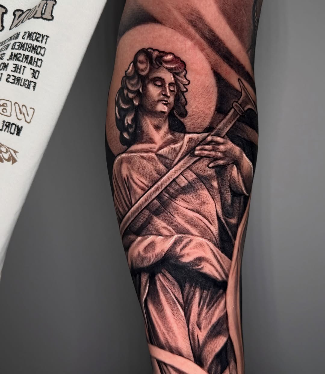 Statue of a man realism tattoo on the forearm by Pablo Venegas