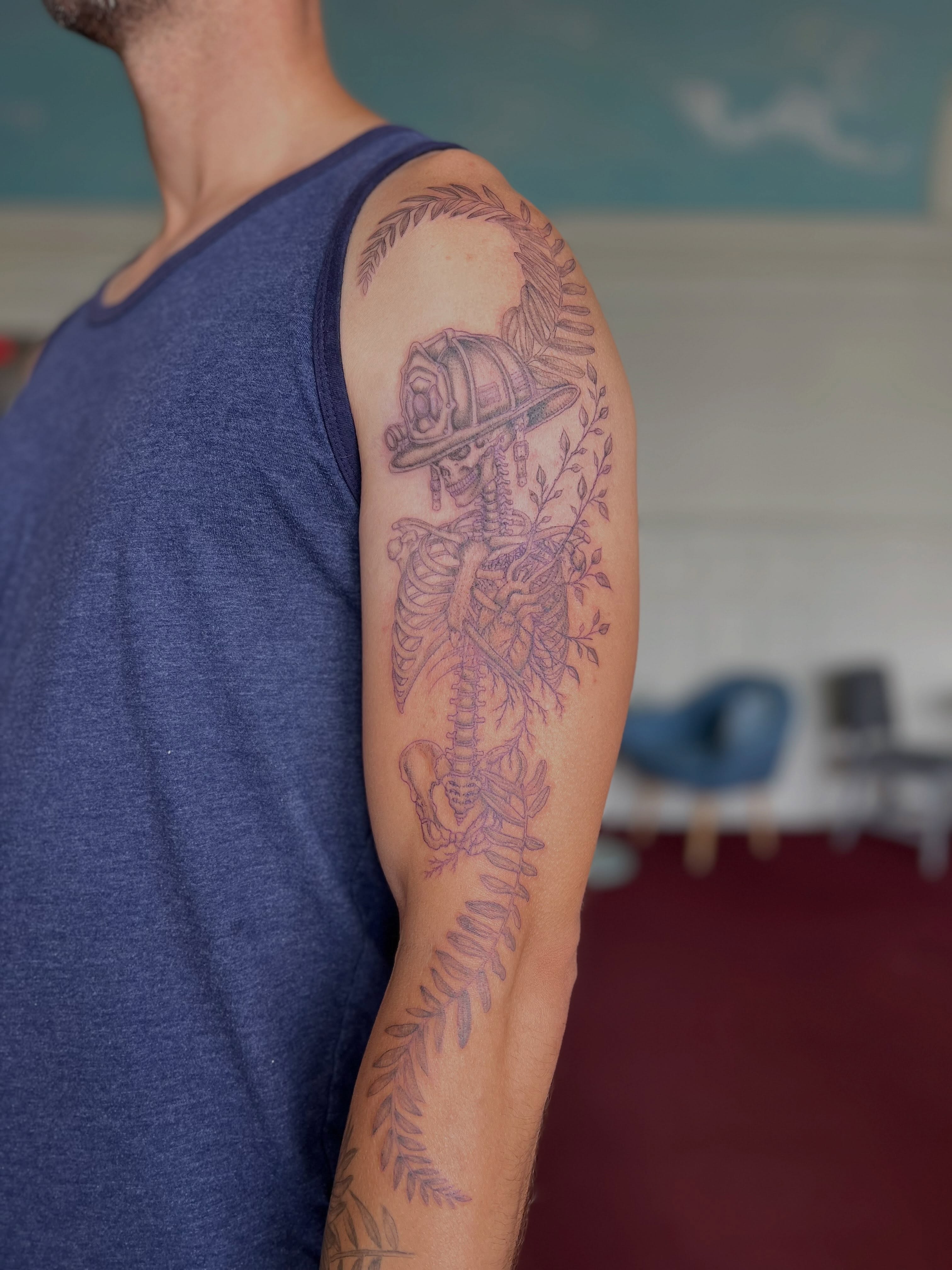 Firefighter skeleton black and grey tattoo on the upper arm by Jordi WA Tacoma Tattooer