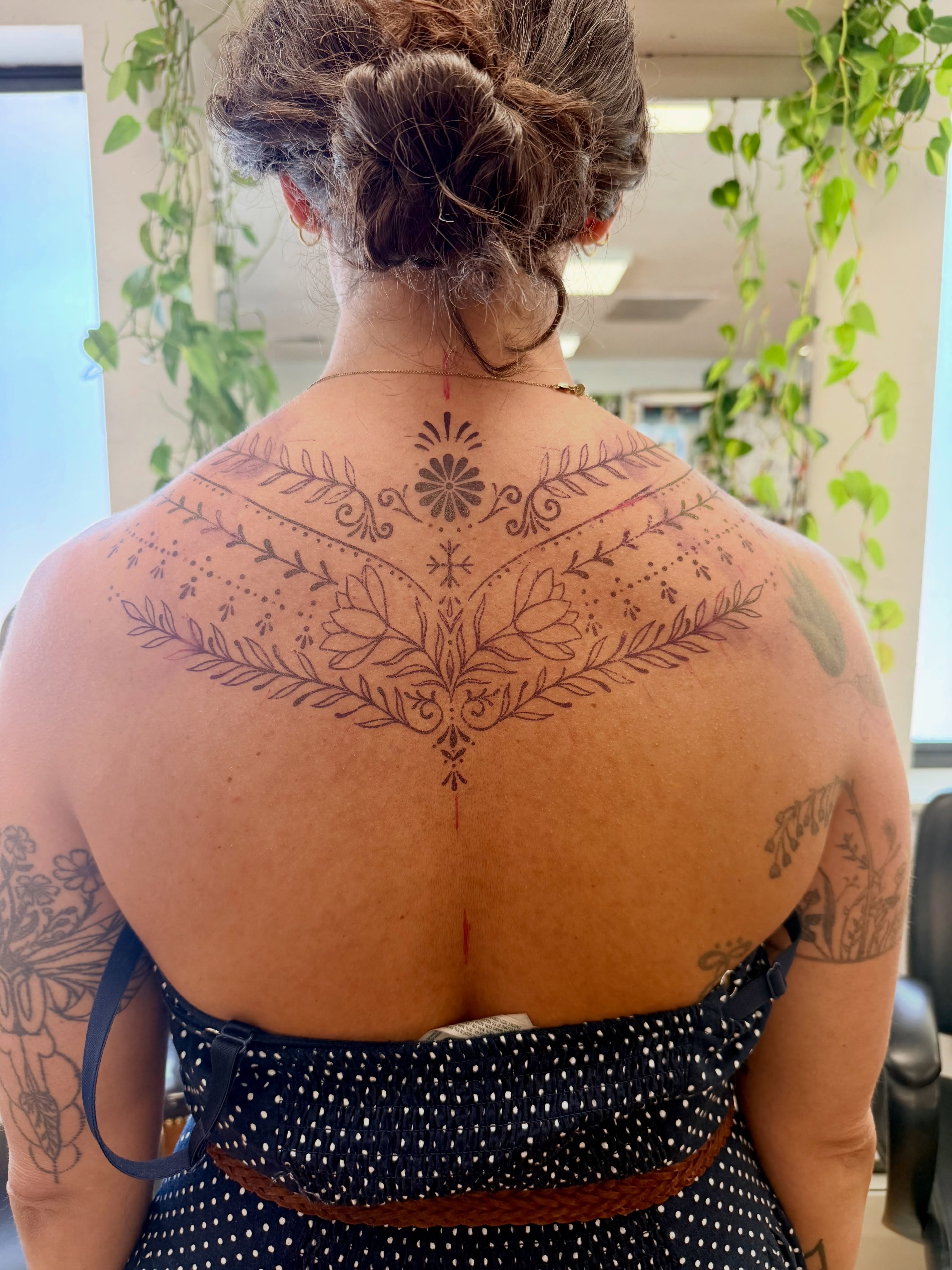 Floral ornamental tattoo on the back by Melia Mariko
