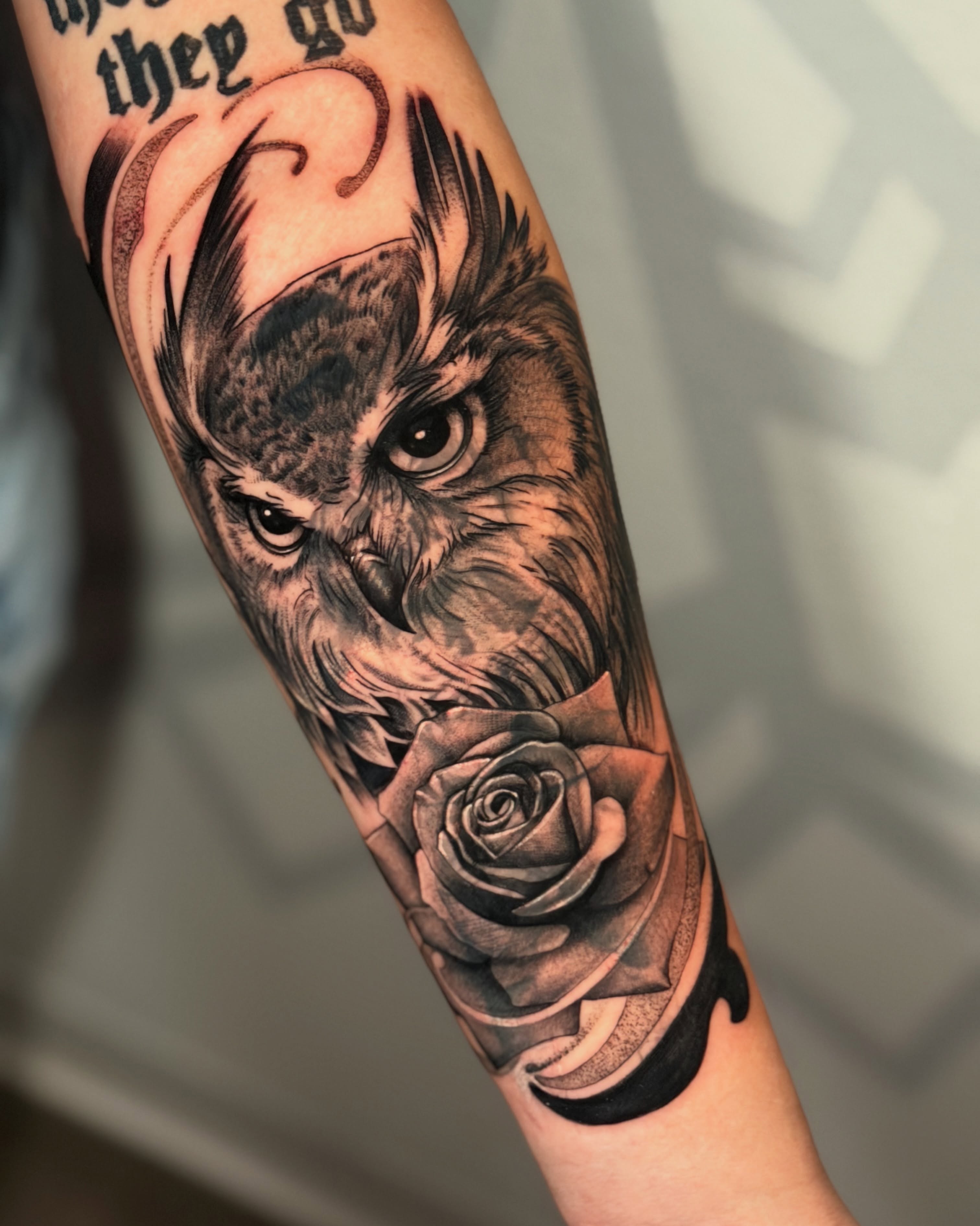 Owl and rose realism tattoo on the forearm by Las Vegas Tattoo Artist