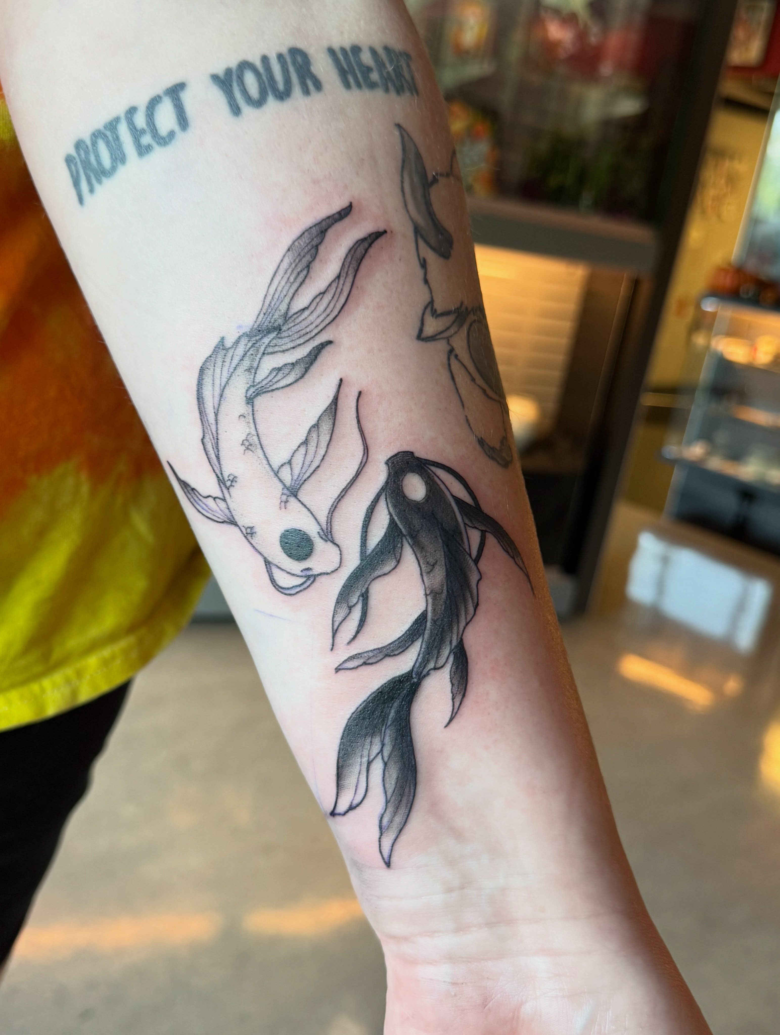 Koi fish black and grey tattoo on the forearm by iz fisch