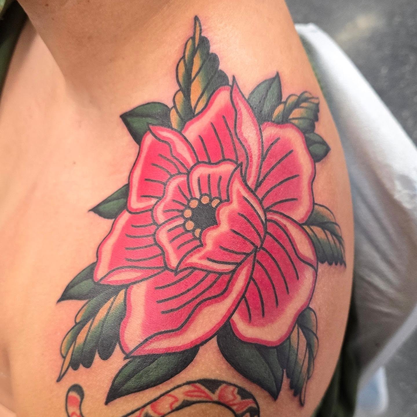 Flower American traditional tattoo on the upper arm by A. Teixeira, Los Angeles, California