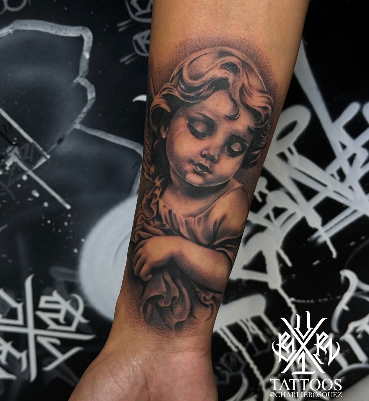Cherub realism tattoo on the forearm by El Beaver Tattoos