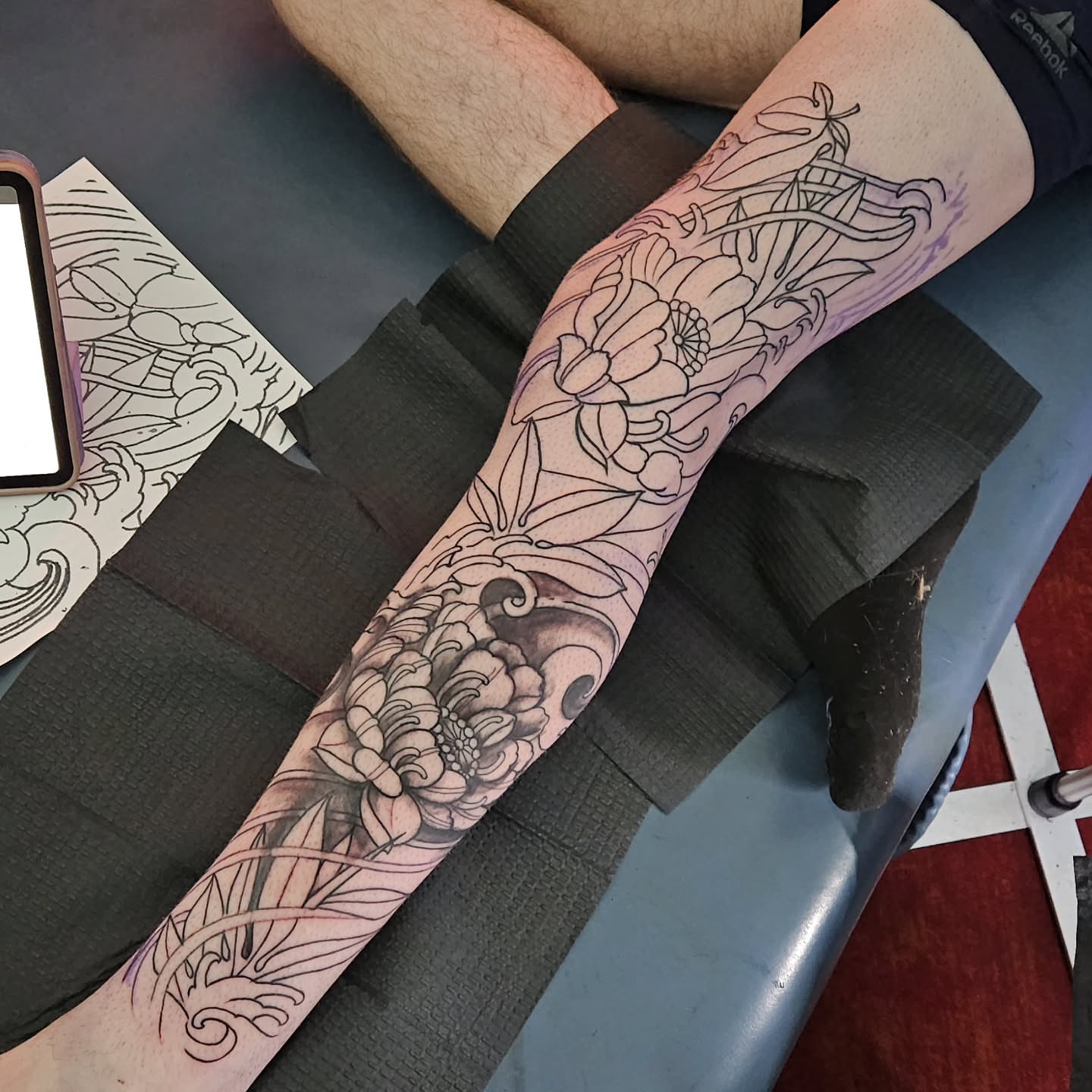 Floral design black and grey tattoo on the forearm by Shane Watkins