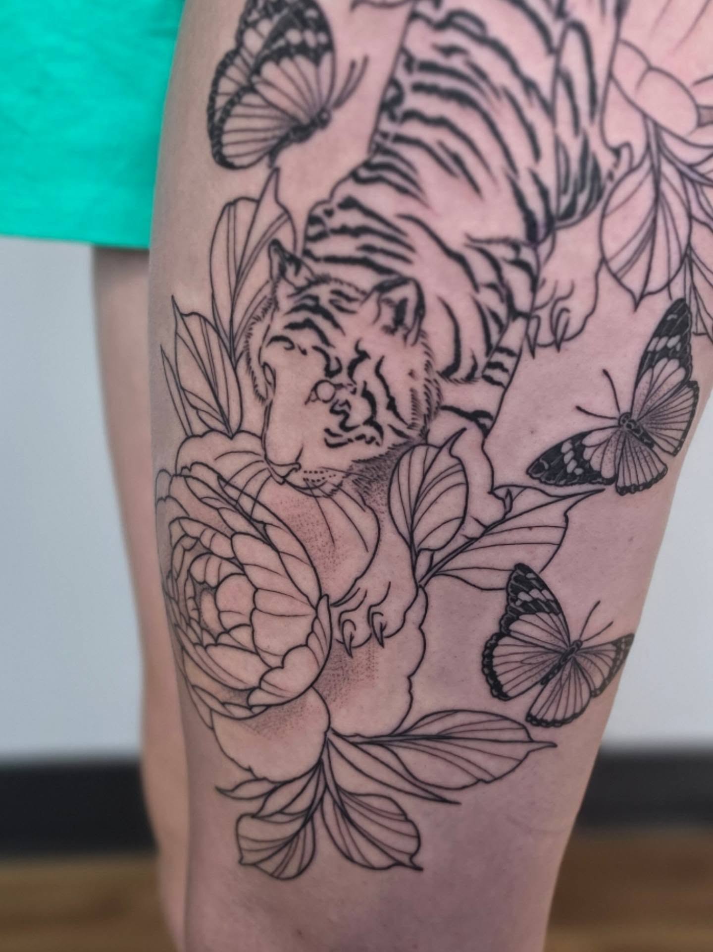 Tiger and butterflies dotwork tattoo on the thigh by Colleen