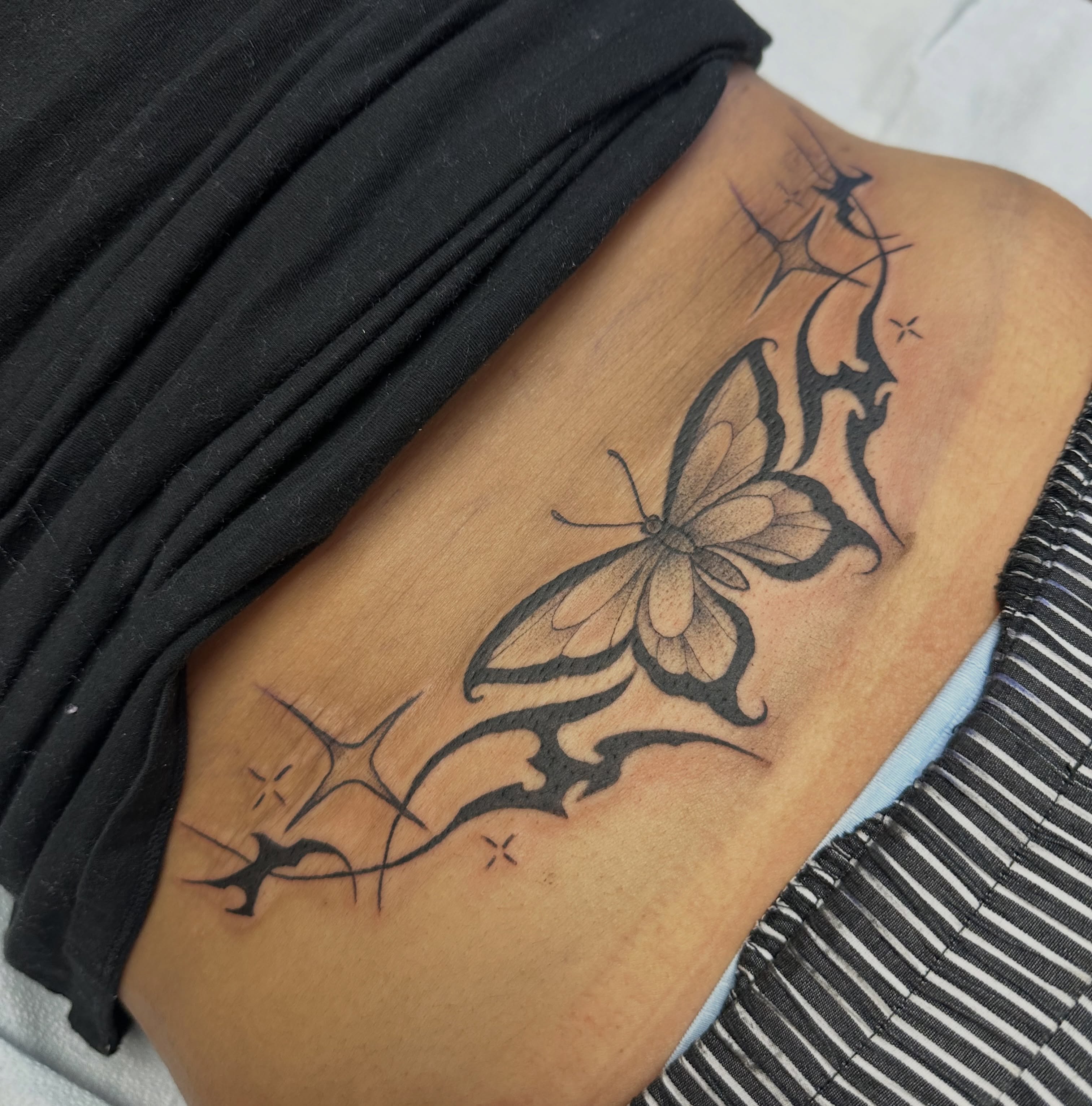 Butterfly tribal tattoo on the thigh by Mia Layne 🤎