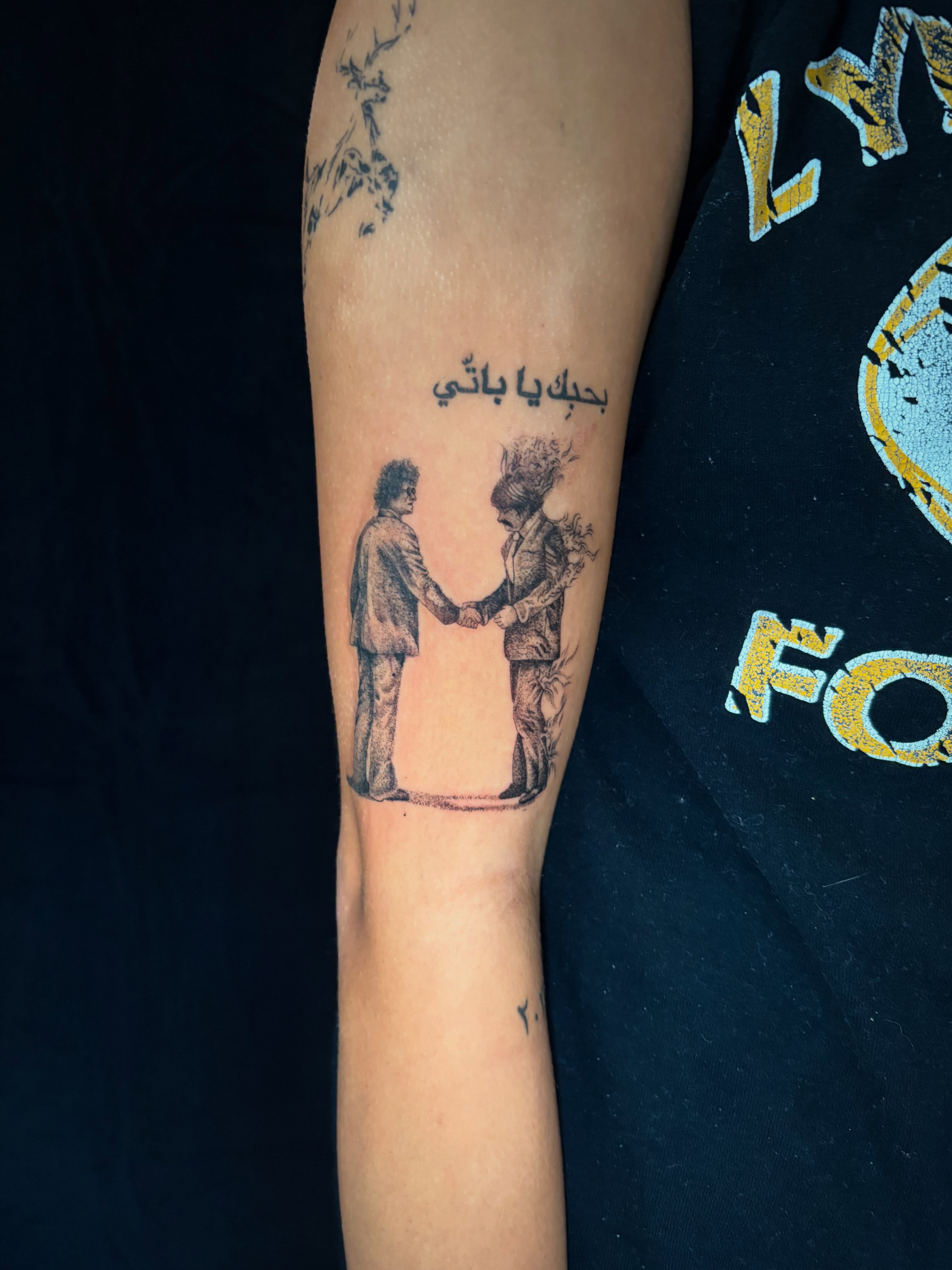 Handshake black and grey tattoo on the forearm by Kimberly Shordon