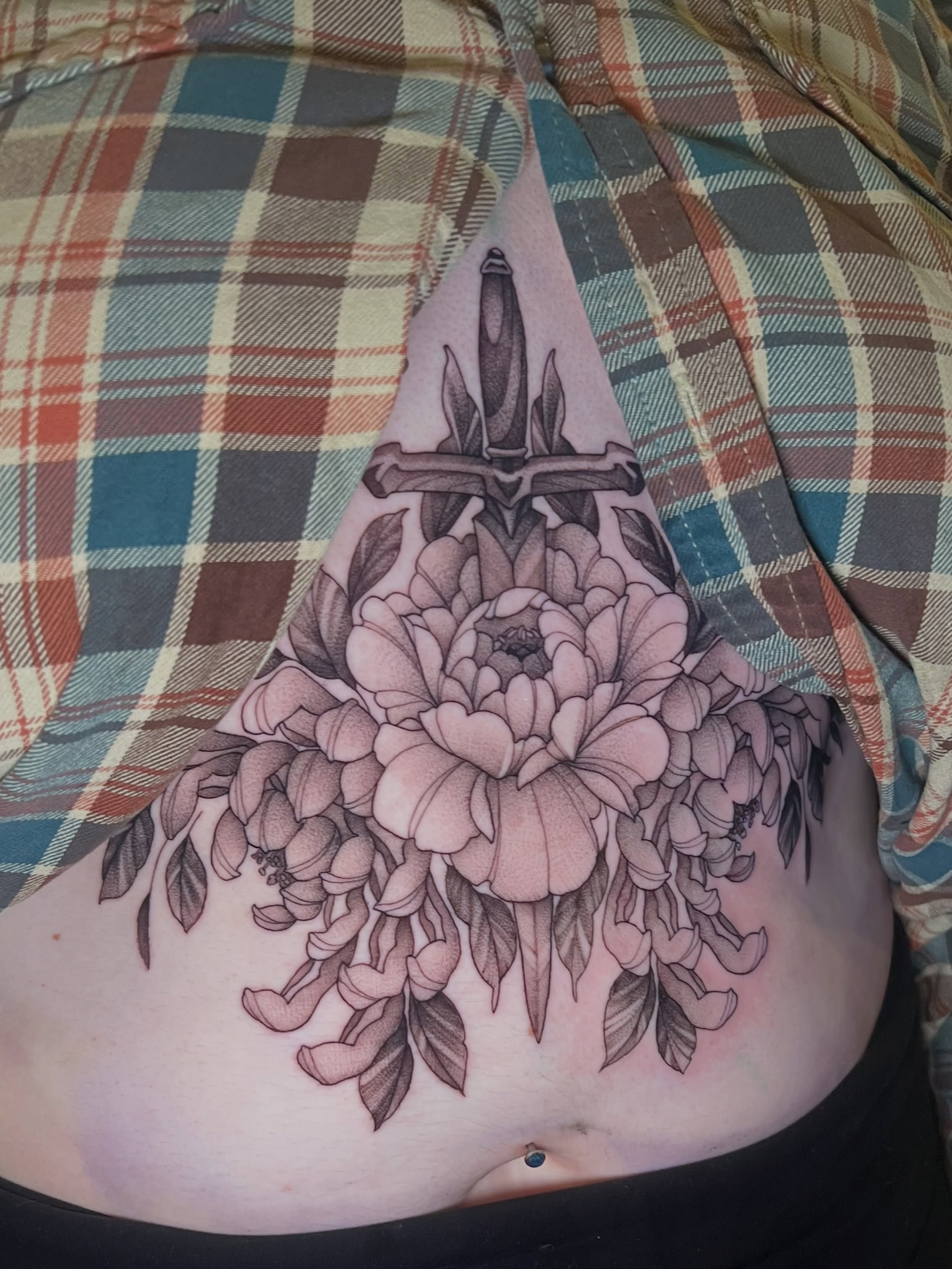 Peony and dagger black and grey tattoo on the torso by Millie, Maryville, Tennessee
