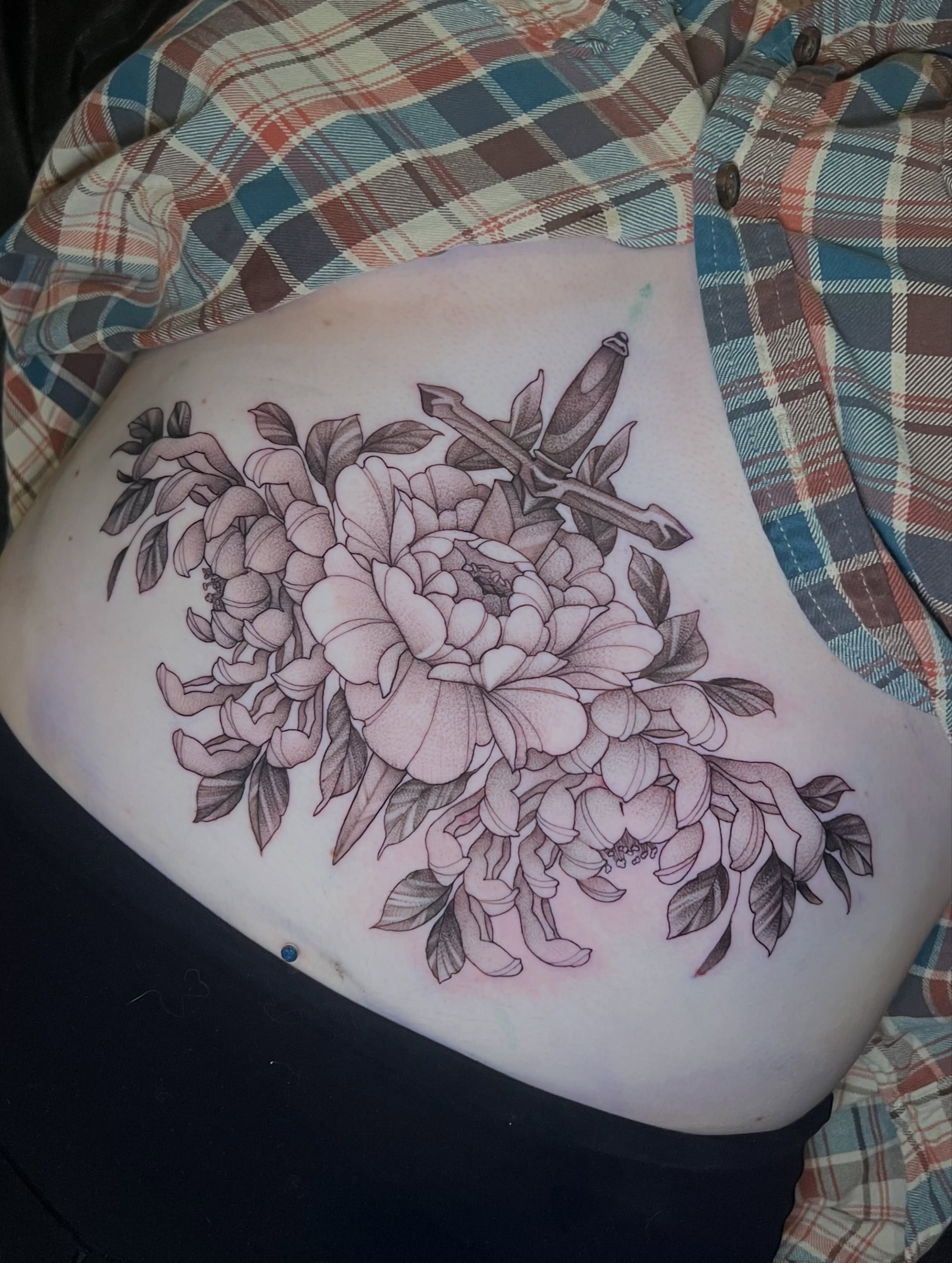 Peony and cross black and grey tattoo on the torso by Millie, Maryville, Tennessee