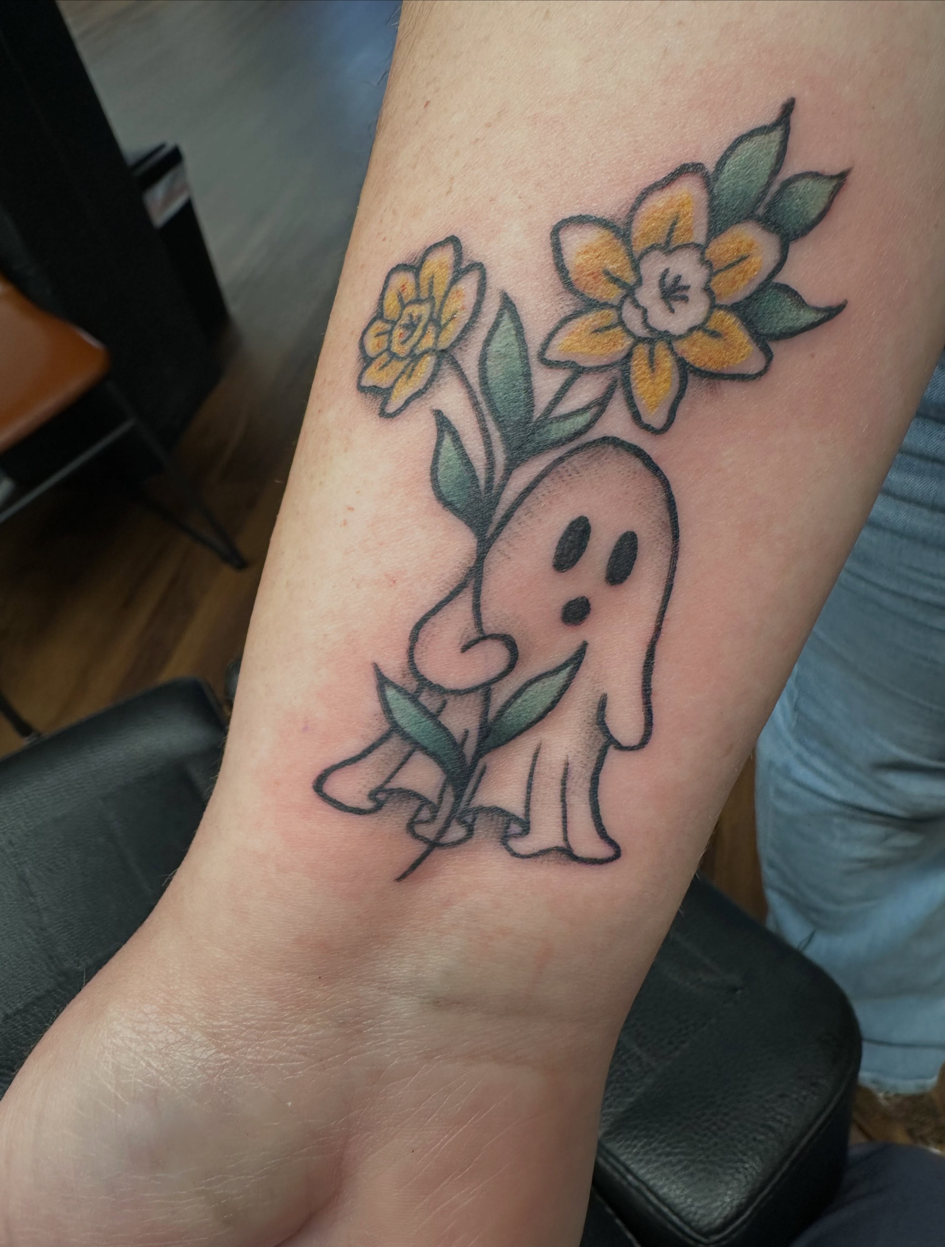 Ghost with flowers new school tattoo on the forearm by Lindsey Bendsey