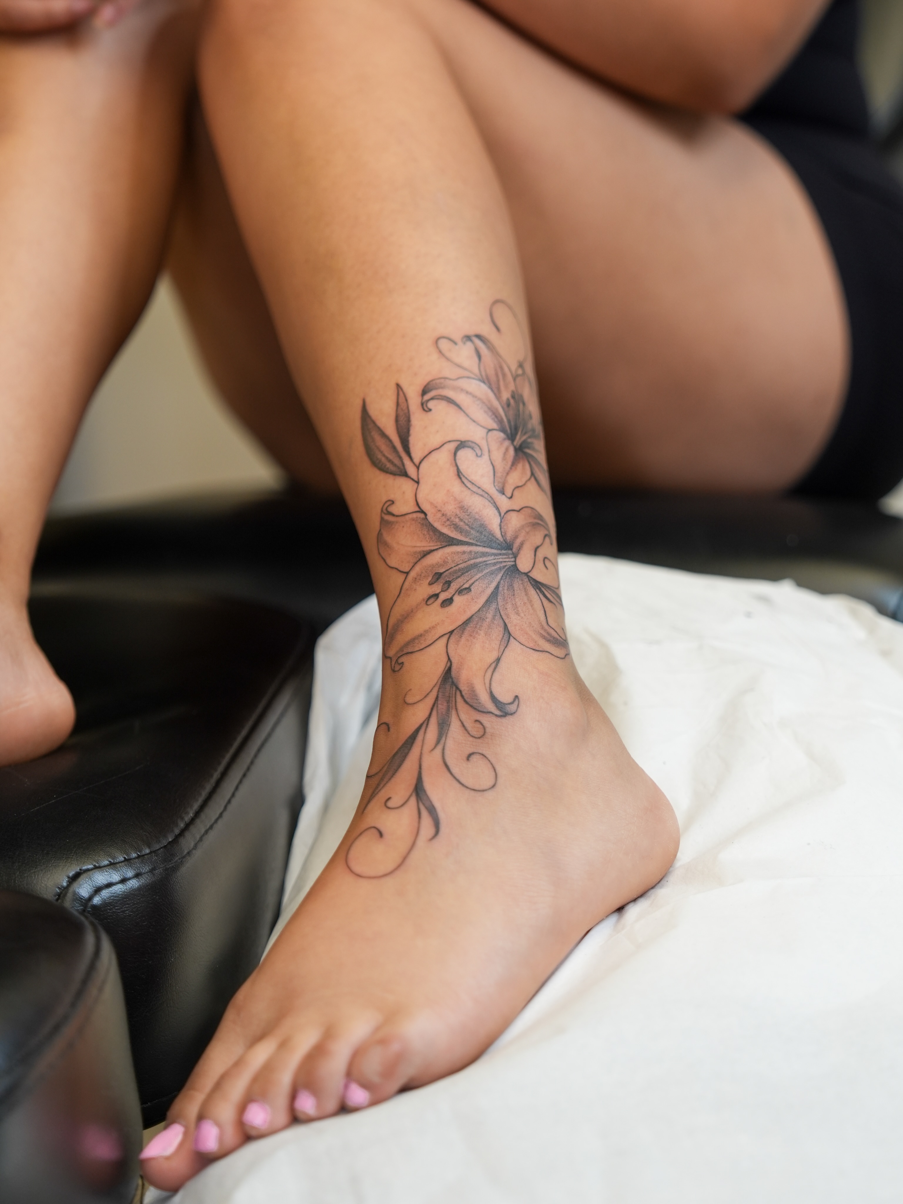 Lily black and grey tattoo on the foot by Kevin Betancourt