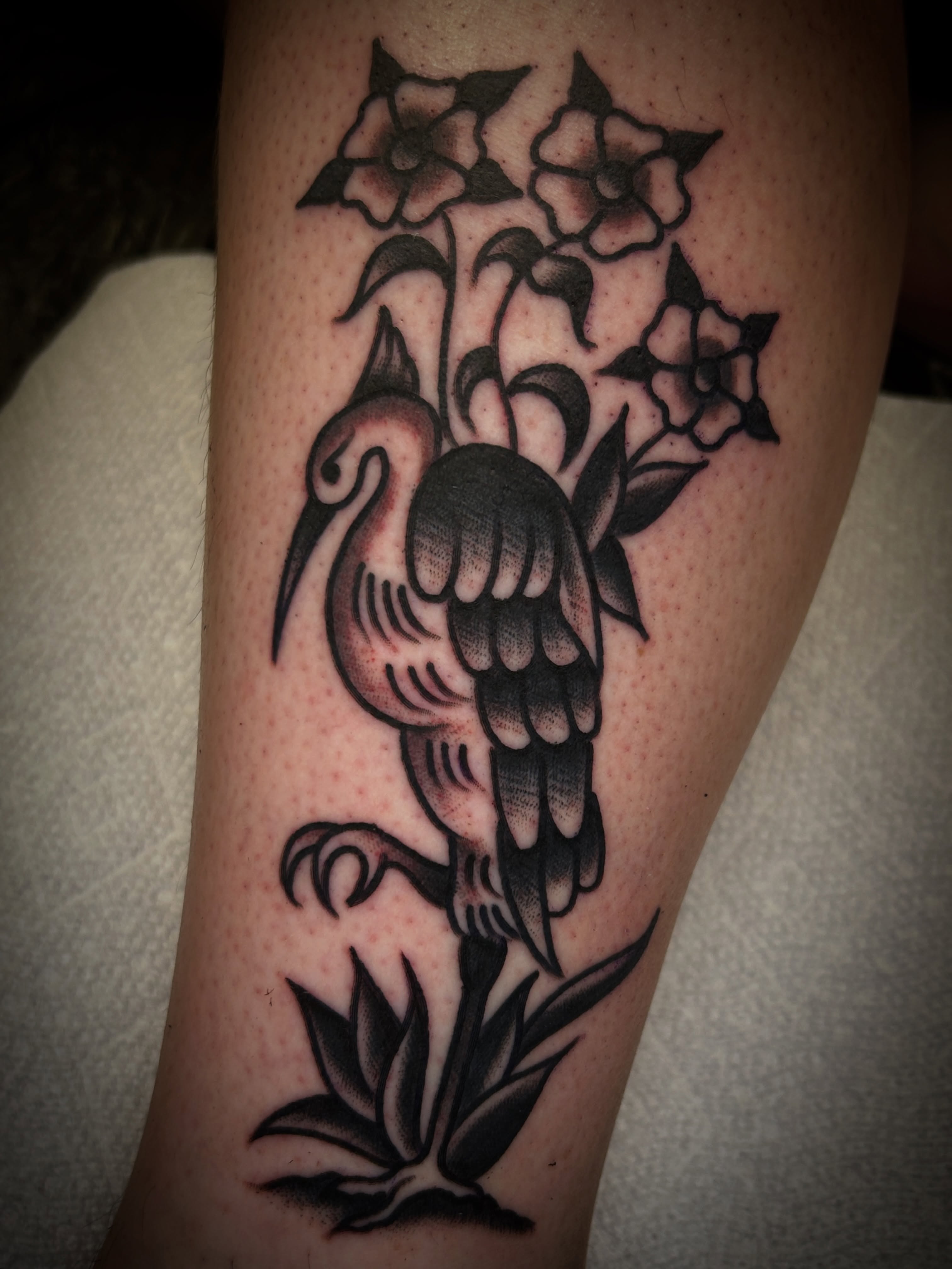 Flamingo and flowers American traditional tattoo on the thigh by Eric Caudill, Indianapolis, Indiana