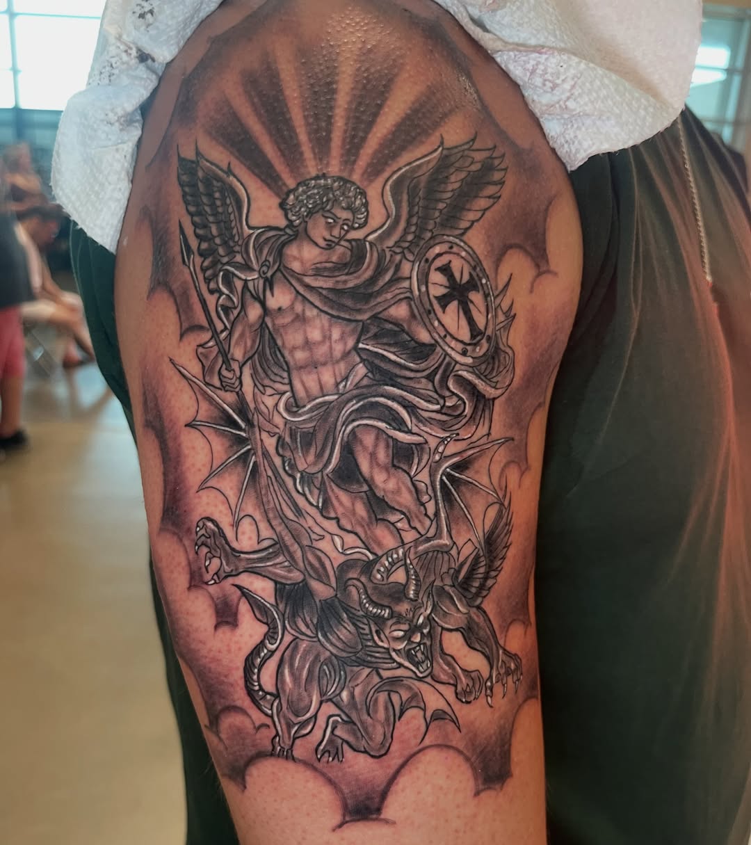 Angel slaying dragon realism tattoo on the upper arm by Tattsruru