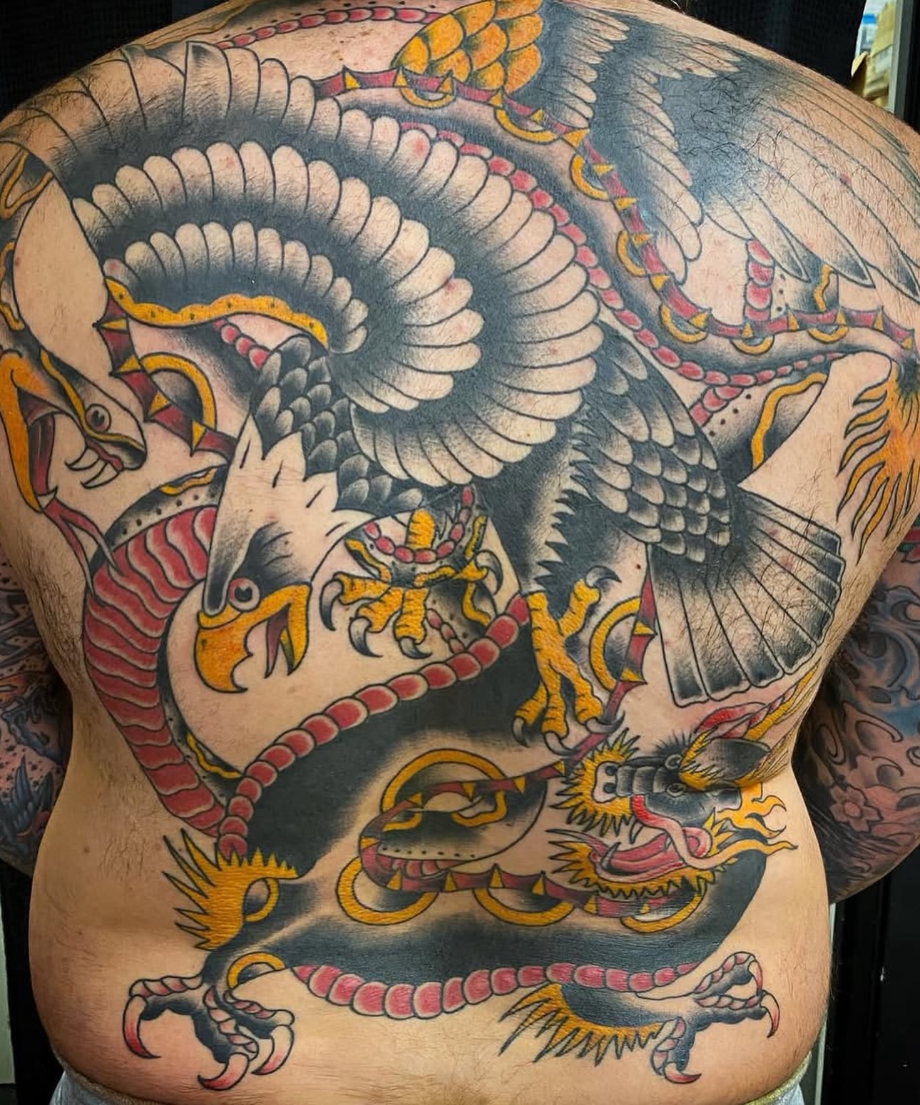 Eagle and dragon American traditional tattoo on the back by Keith Underwood