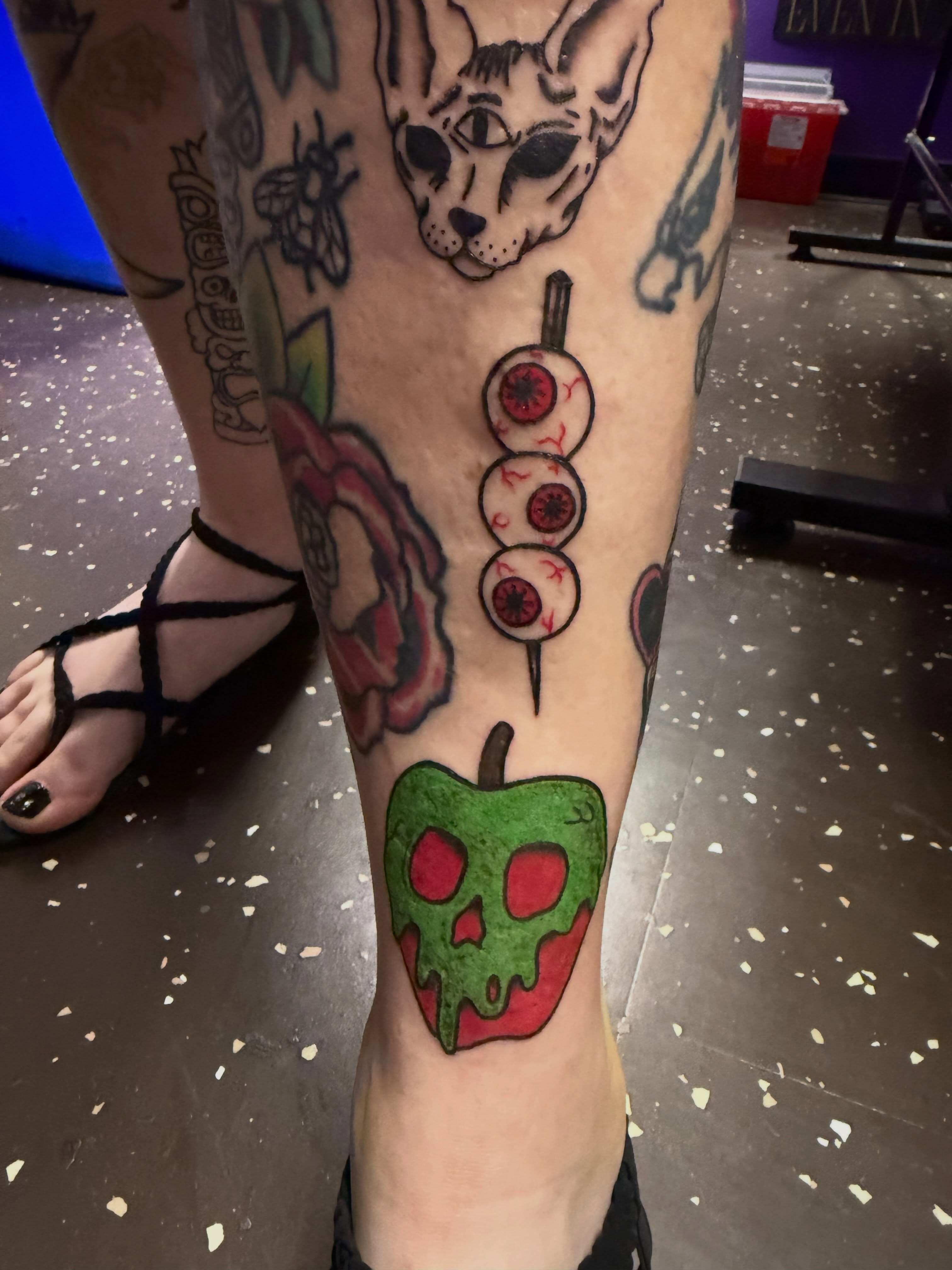 Apple with skull dotwork tattoo on the leg by Drew