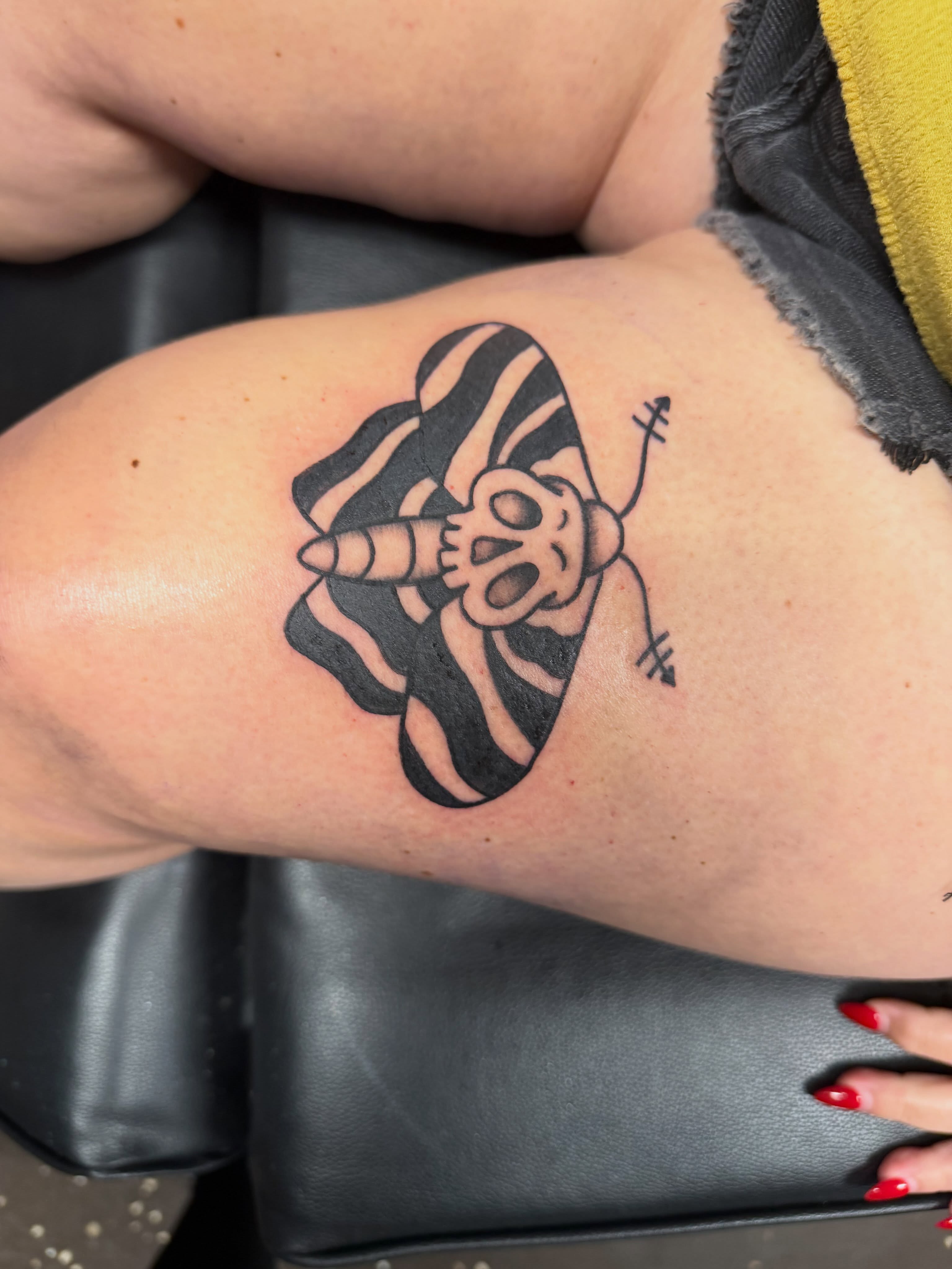 Bee black and grey tattoo on the thigh by Drew
