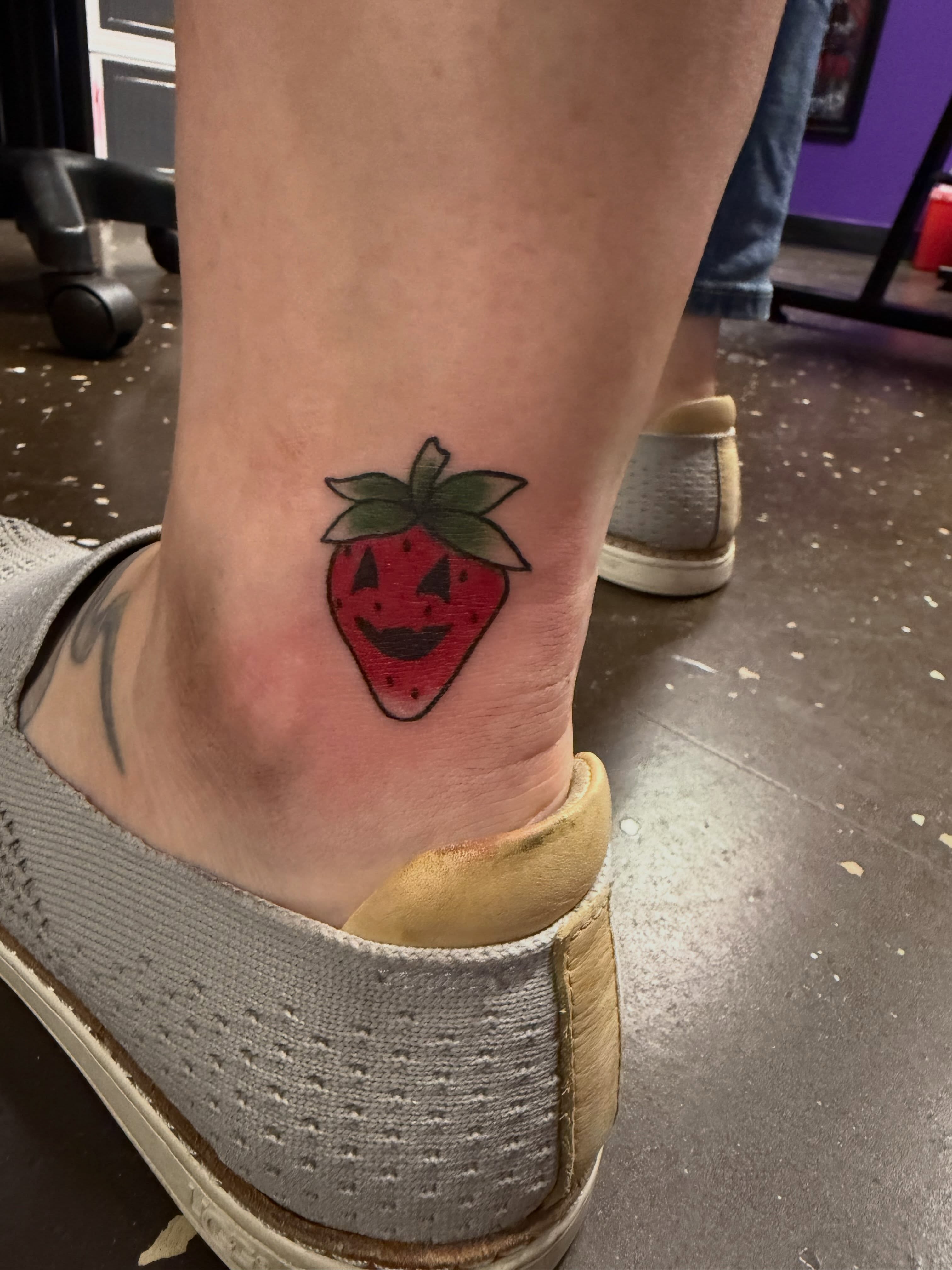 Strawberry American traditional tattoo on the foot by Drew
