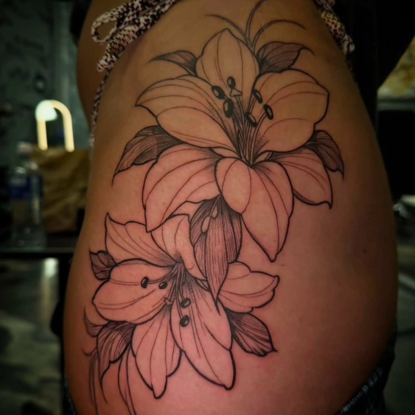 Lilies black and grey tattoo on the thigh by 𝕸 𝖆 𝖓 𝖔 𝖑 𝖔
